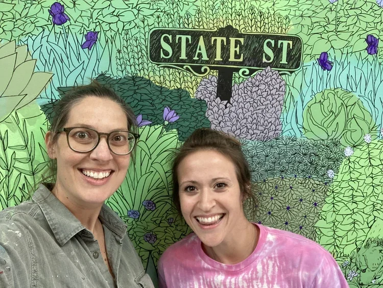 Lead artist Claudia Buchanan (left) and assistant painter Rachel Sebelist (right)