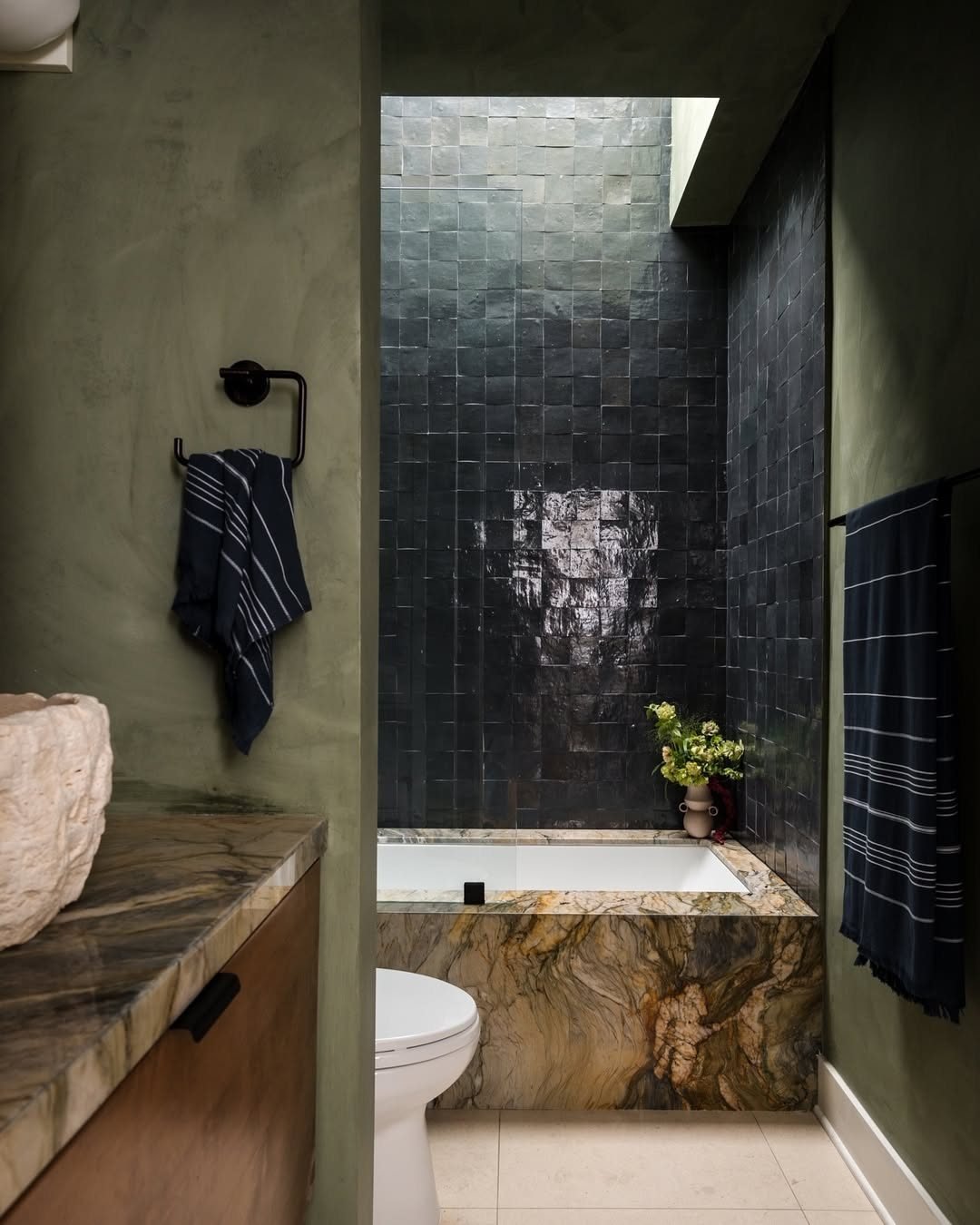 When it comes to designing a bathroom, balance is key, especially when working with moody tones. This stunning bathroom by @sagradastudio is a perfect example of how contrasting organic materials can elevate a space.

The rich quartzite slab, raw-edg