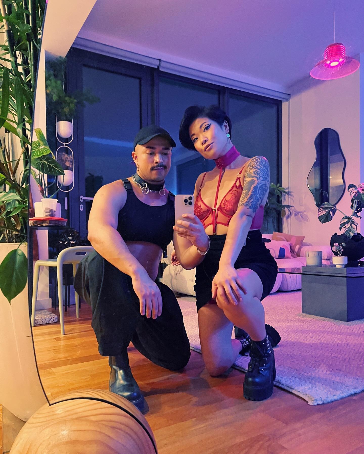 Nine years older, wiser, and spicier 🌶️ What a gift to be aging gracefully alongside friends like @davidvillouta 🥹

[Image descriptions: 1. A mirror selfie of Lauren and David dressed in crop tops and black boots in a plant-filled apartment at nigh