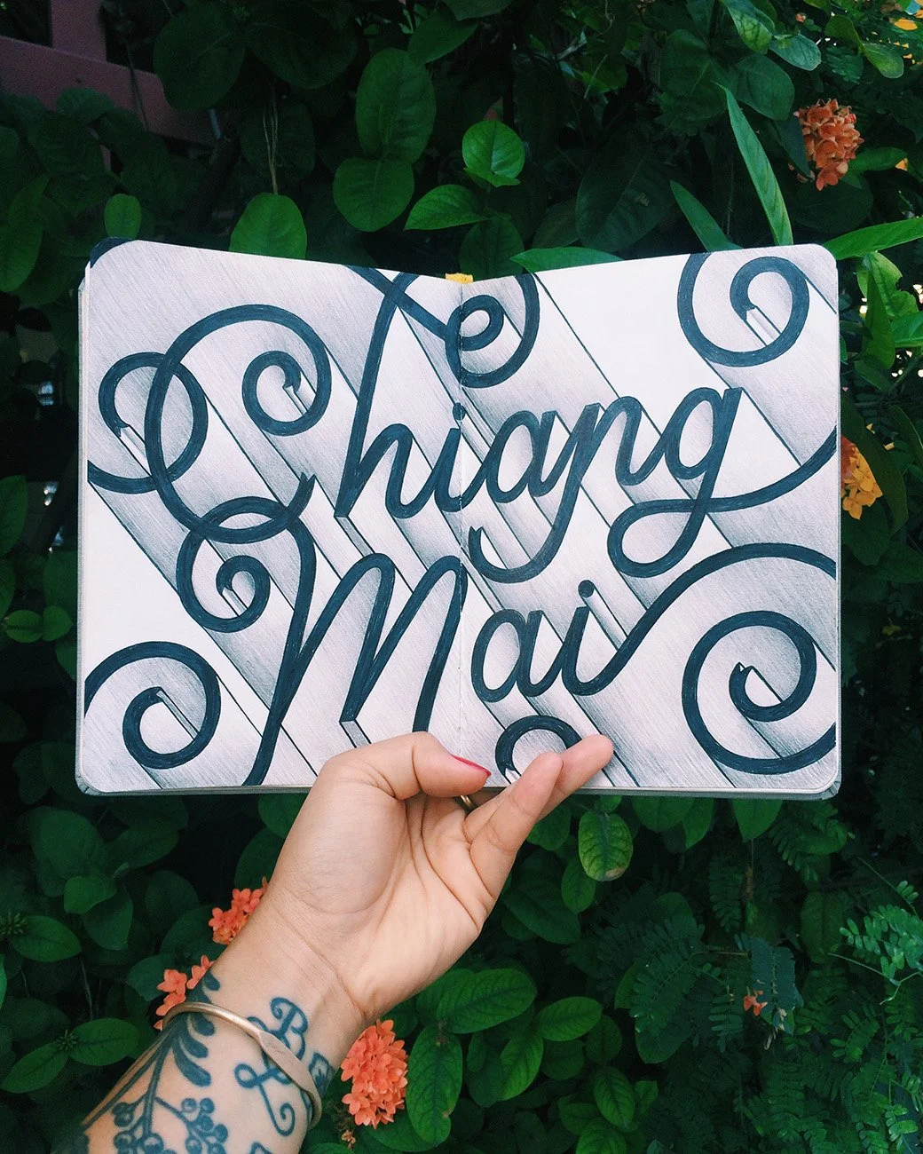 Sketchbook spread reading "Chiang Mai" in three-dimensional, shaded letters.