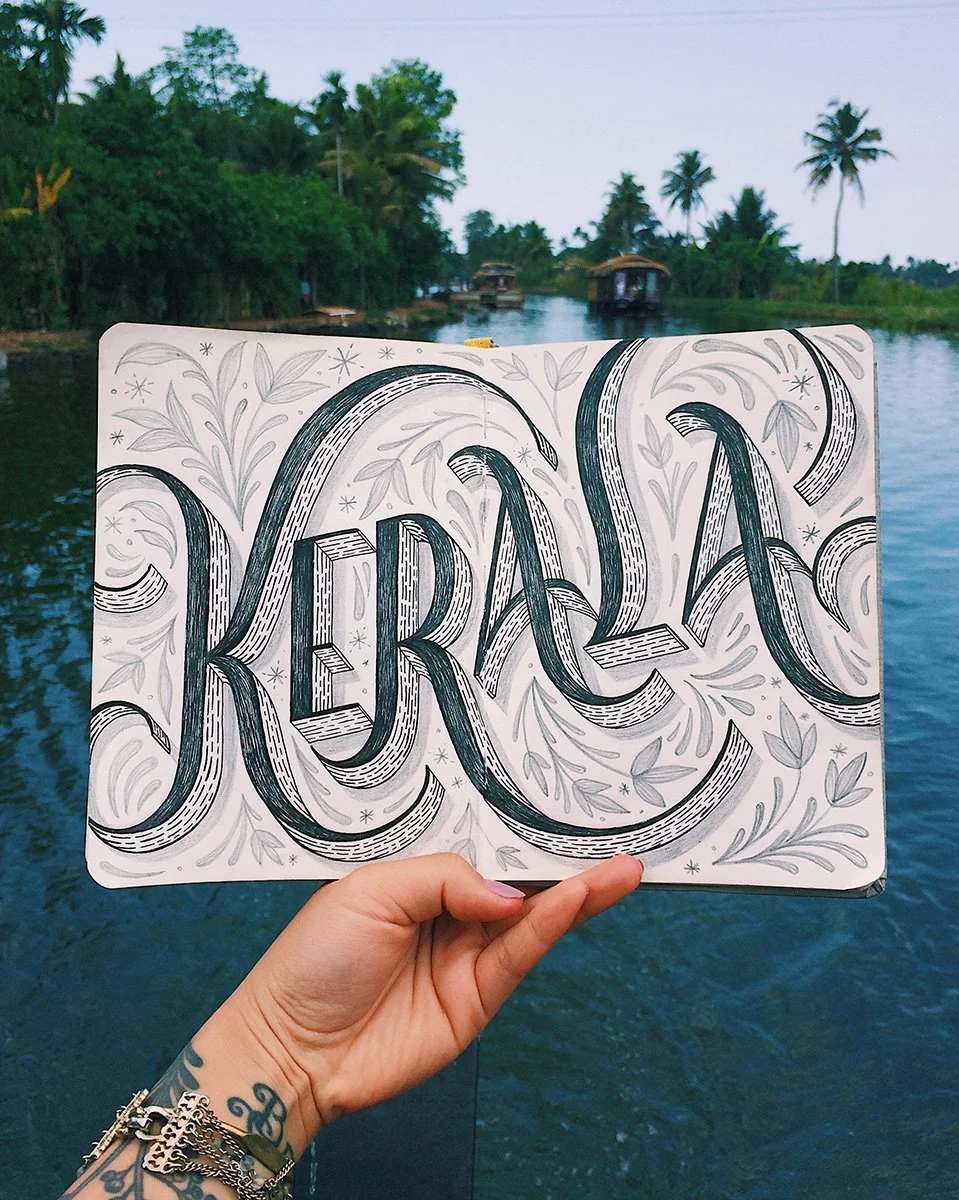 Detailed sketchbook spread reading "Kerala" surrounded by botanical illustration.