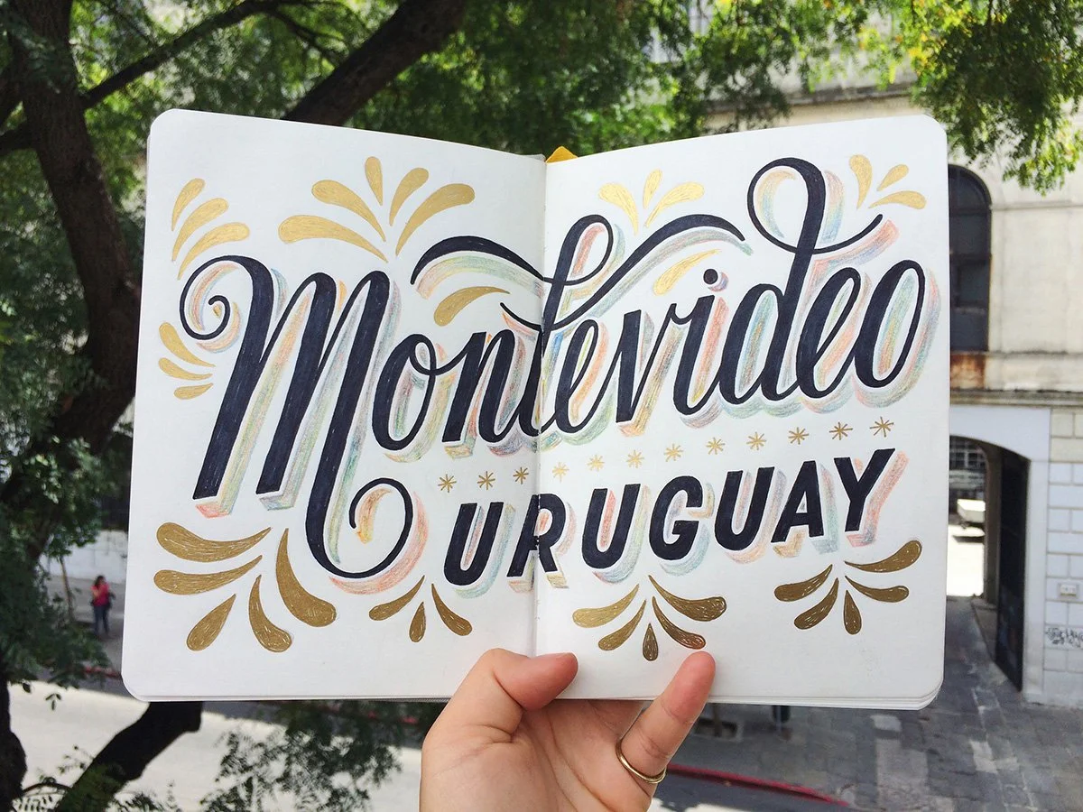 Sketchbook spread reading "Montevideo, Uruguay" surrounded by droplet-shaped flourishes.