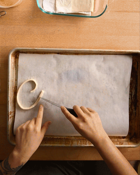 Timelapse of Lauren creating the word "Croissants" in puff pastry dough.