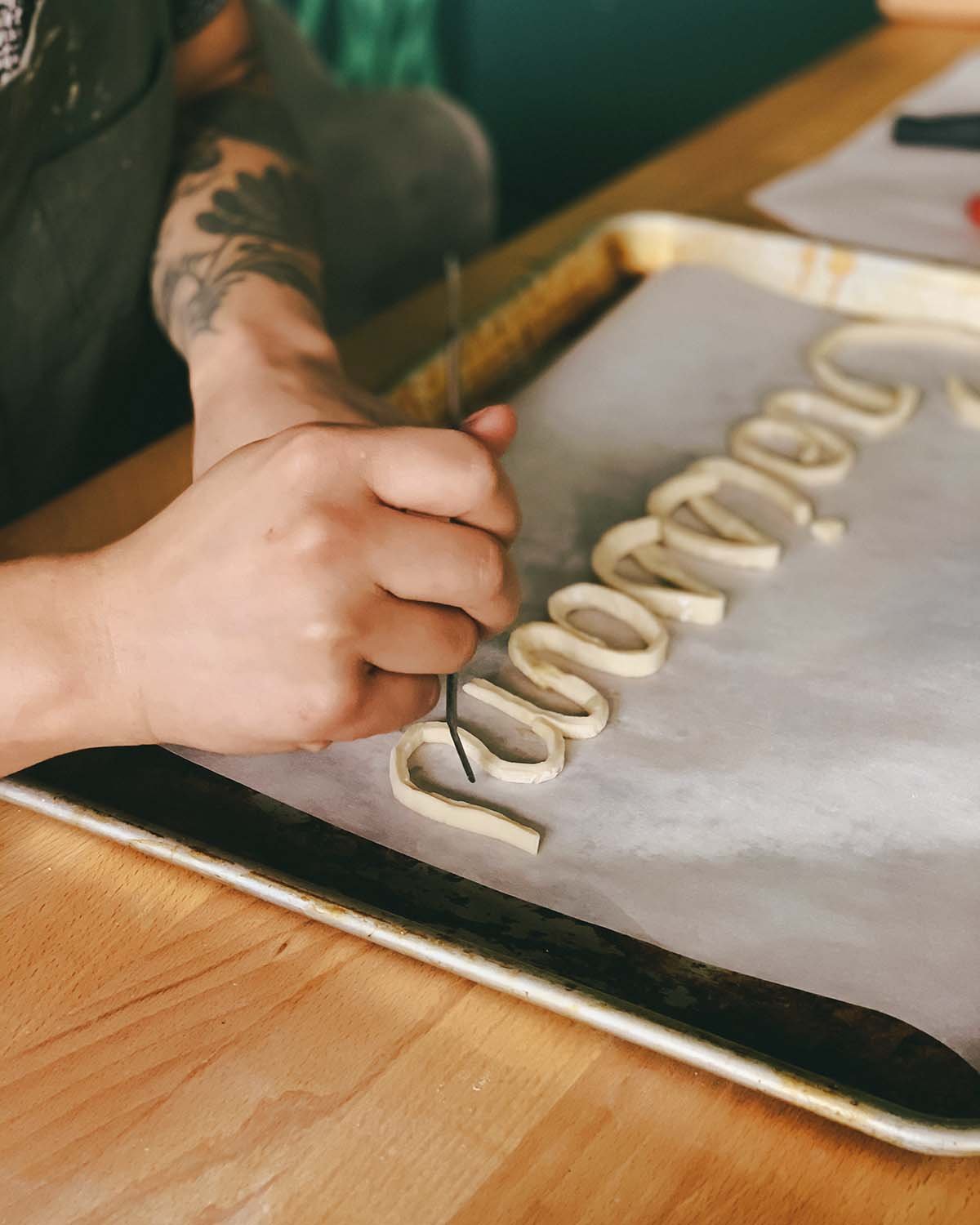 Lauren forming "n" and "t" in puff pastry.
