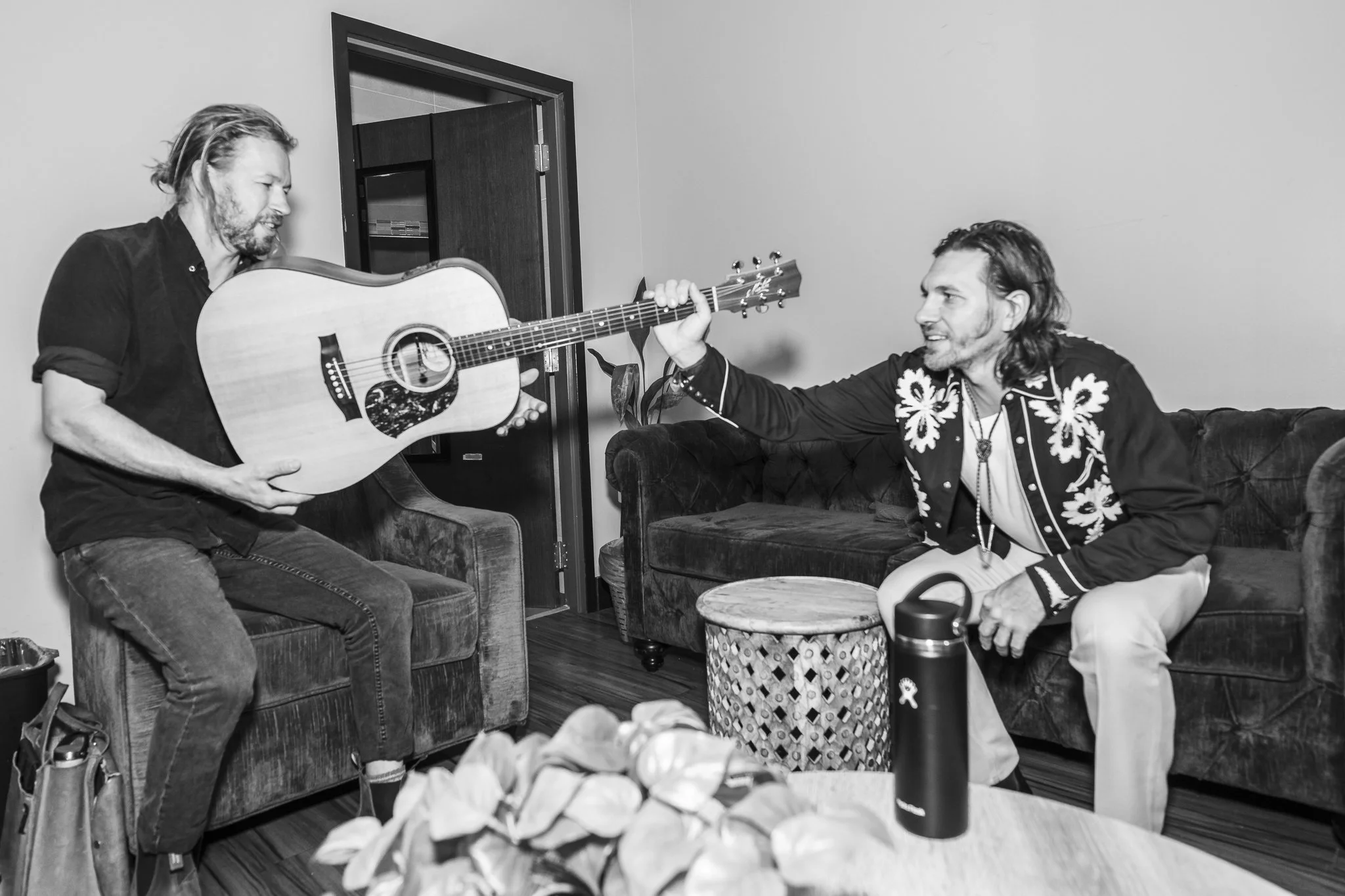 backstage-guitar-handoff-brothers