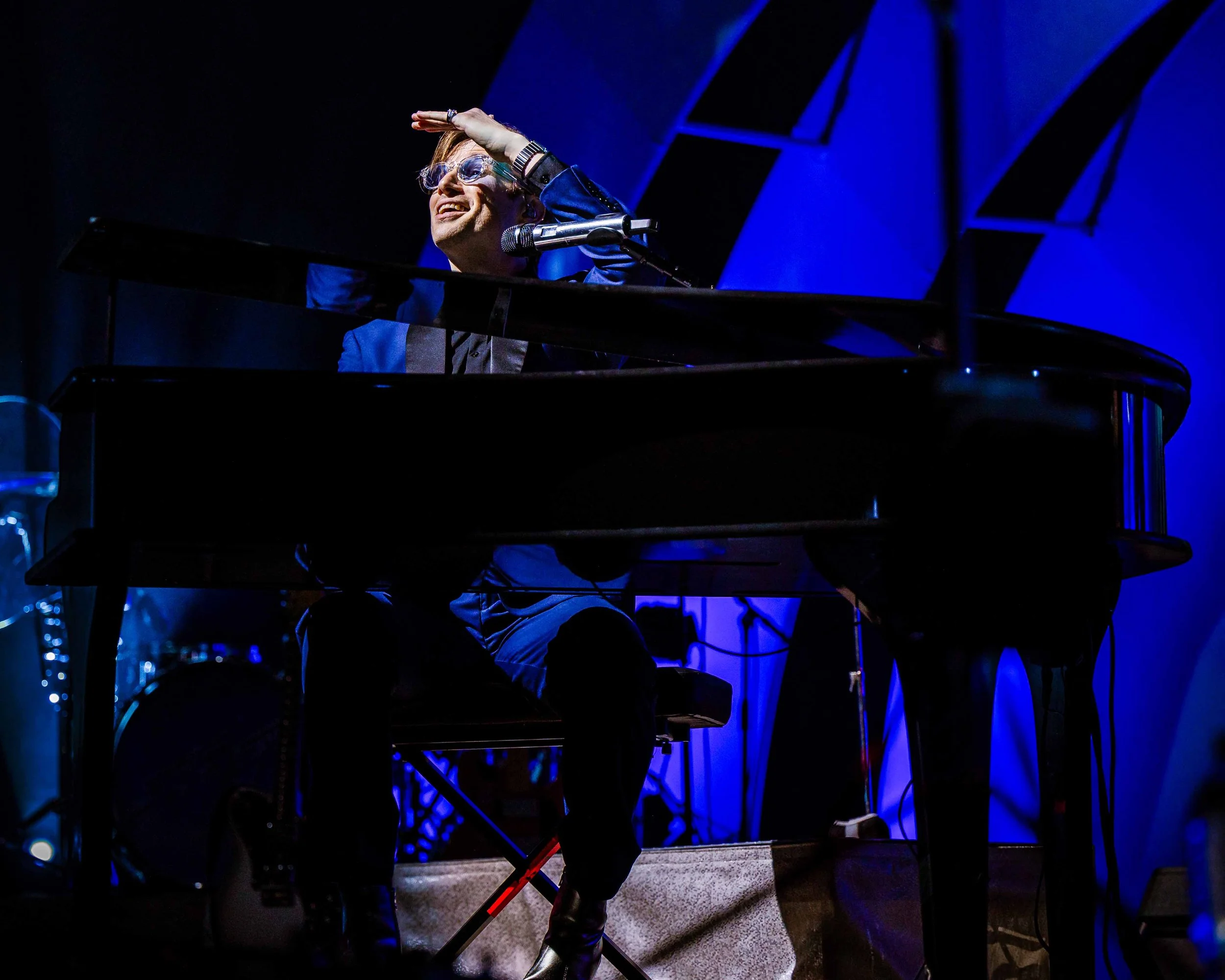 Candid moment of Saint Motel’s lead singer playing piano and connecting with the crowd – live concert photo