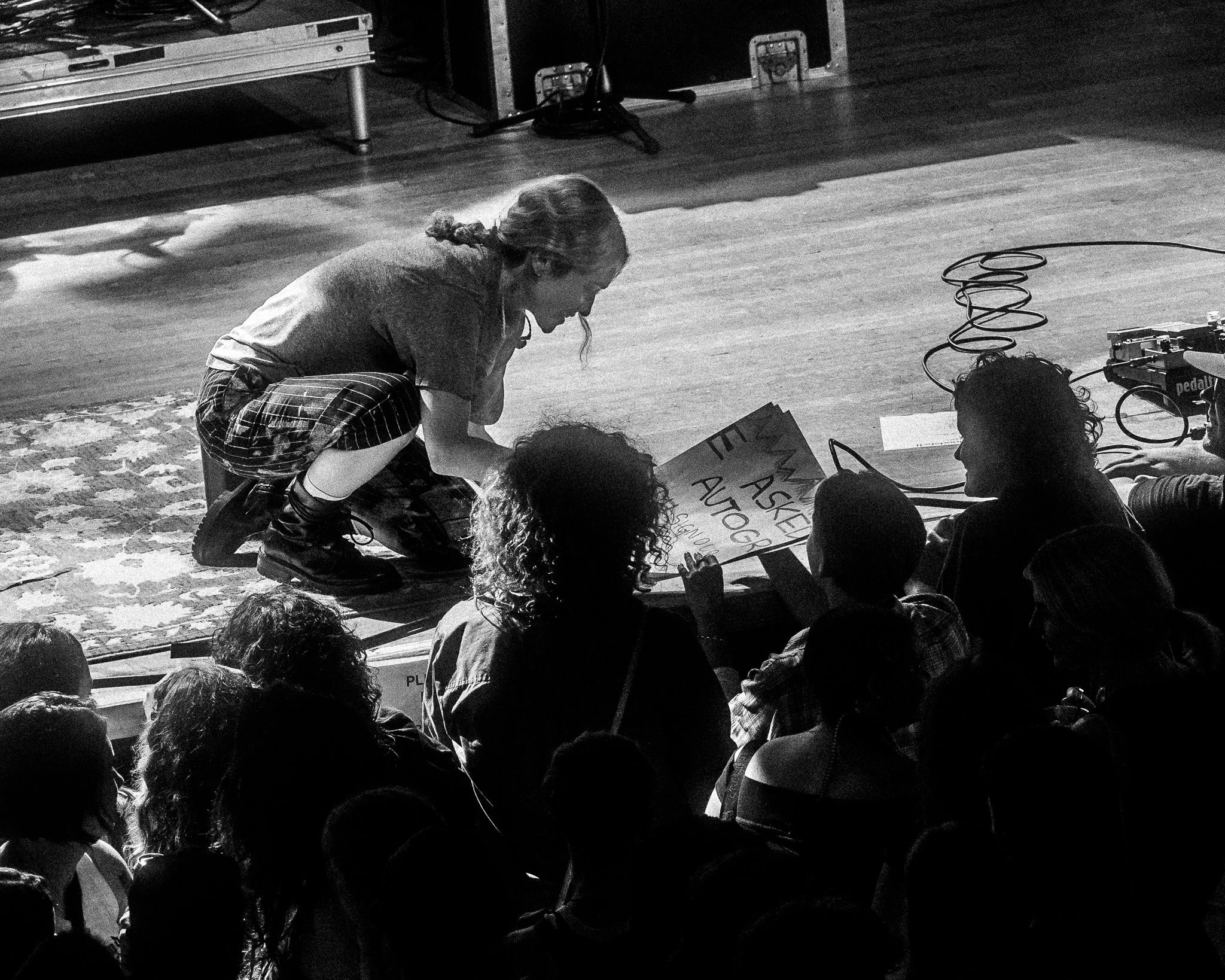 Candid black and white photo of Blondshell signing a fan's poster after her concert at Variety Playhouse in Atlanta