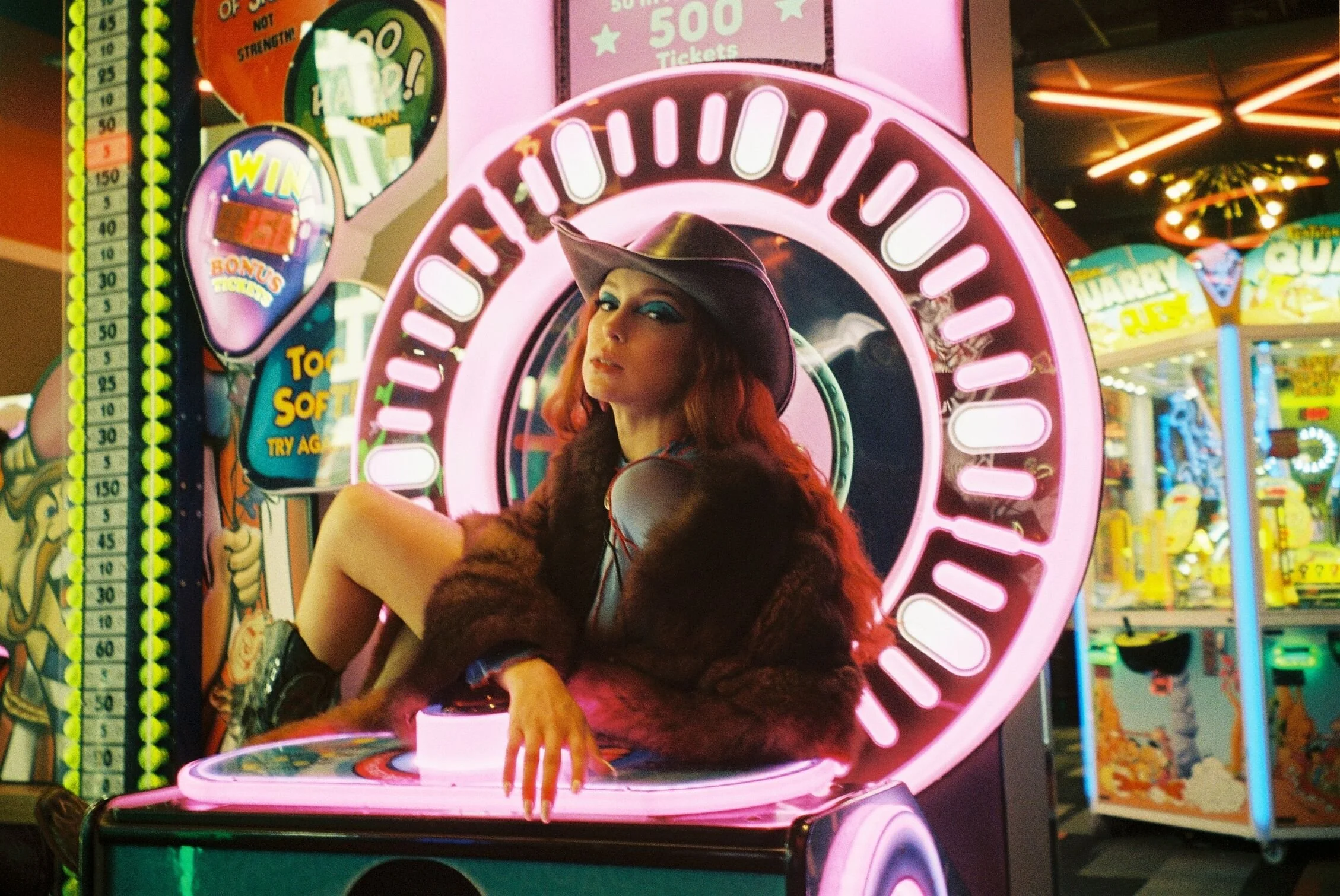 Musician-sitting-on-arcade-machine