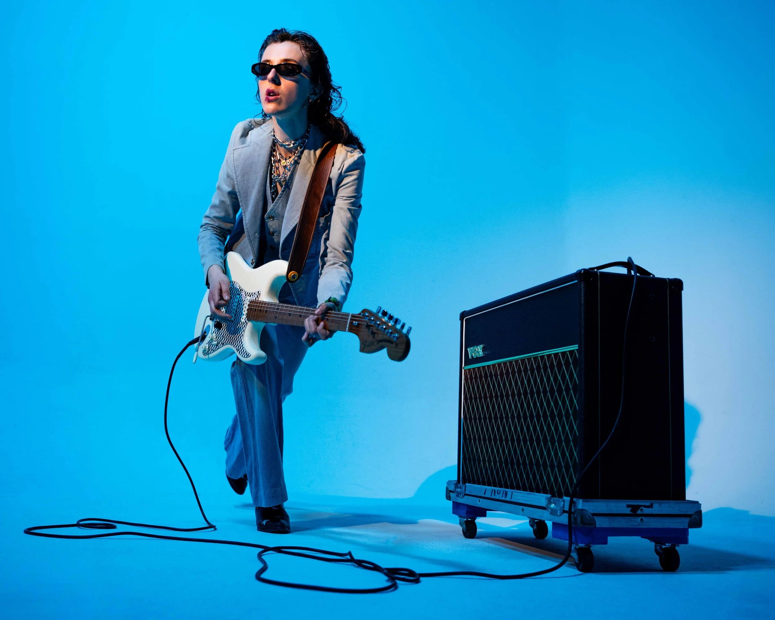 Studio portrait of Nashville’s Gloomgirl MFG – inspired by Robert Pattinson's GQ look, featuring her guitar and amp