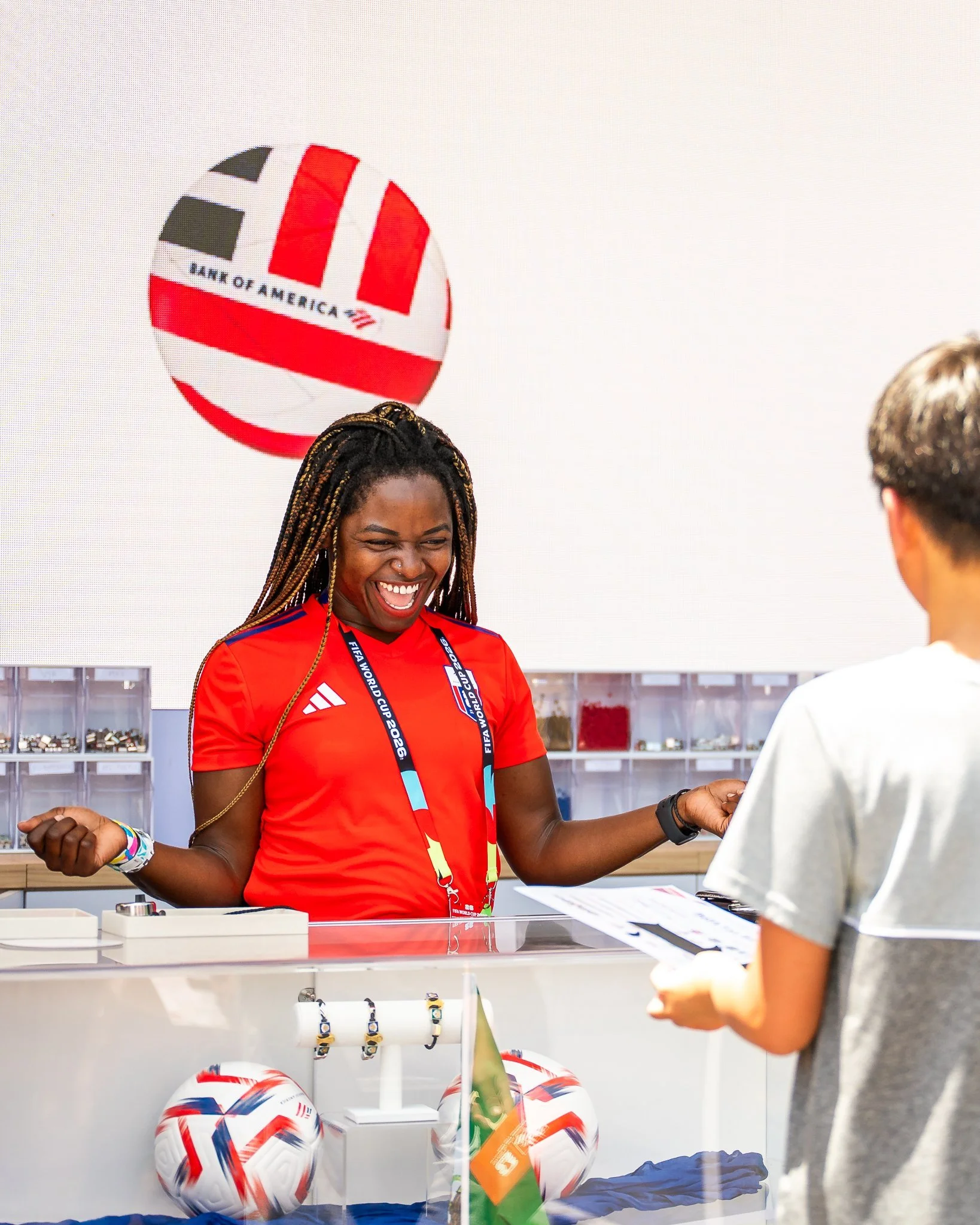 Bank of America ambassador creates a personalized charm bracelet for a guest at FIFA Fan Fest Atlanta as visitors engage with one of the festival's most talked-about experiential marketing activations.