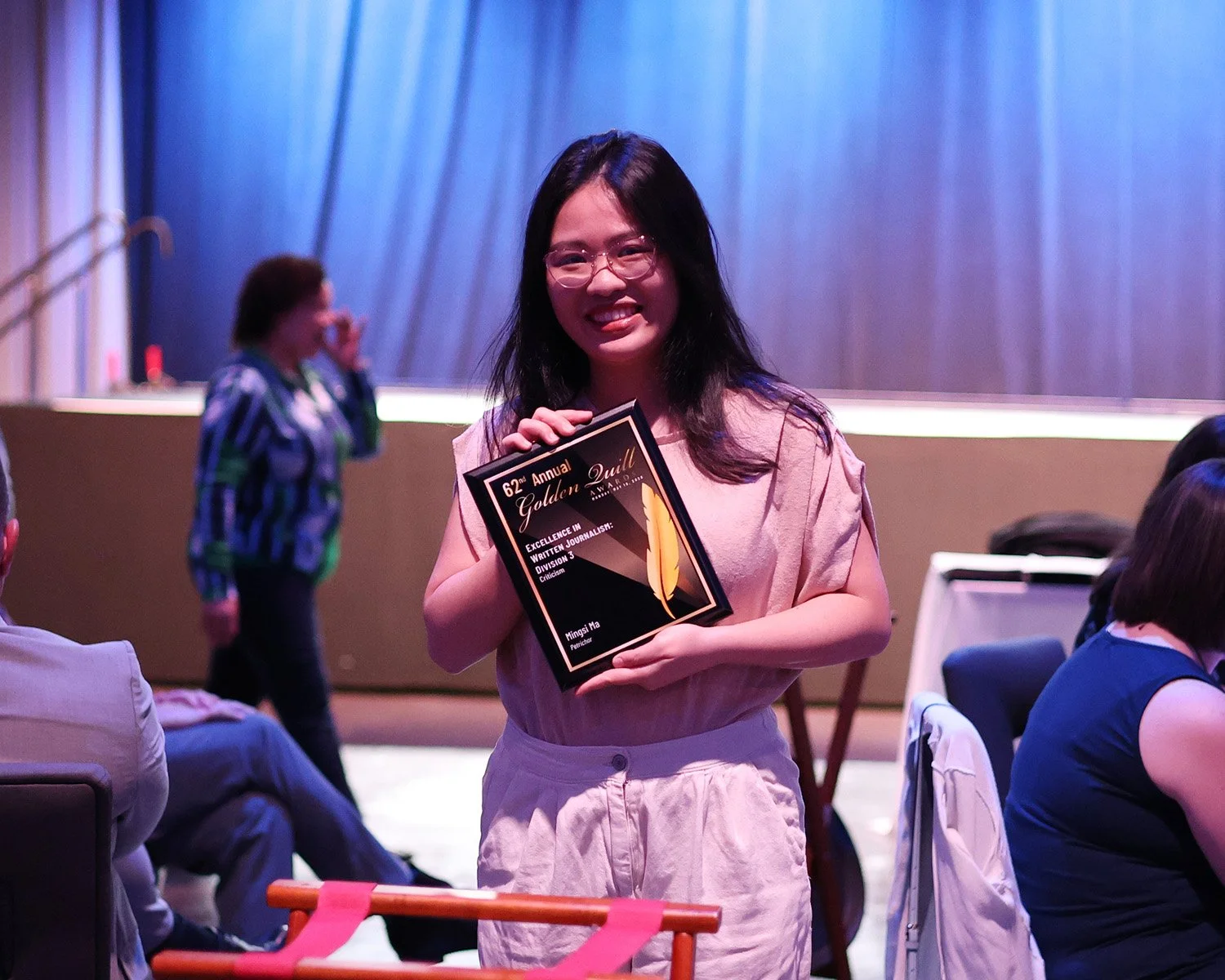 Mingsi Ma shows the 2026 Golden Quill Award she won for her reviews in Petrichor. (Photo by Shayla Fulton)