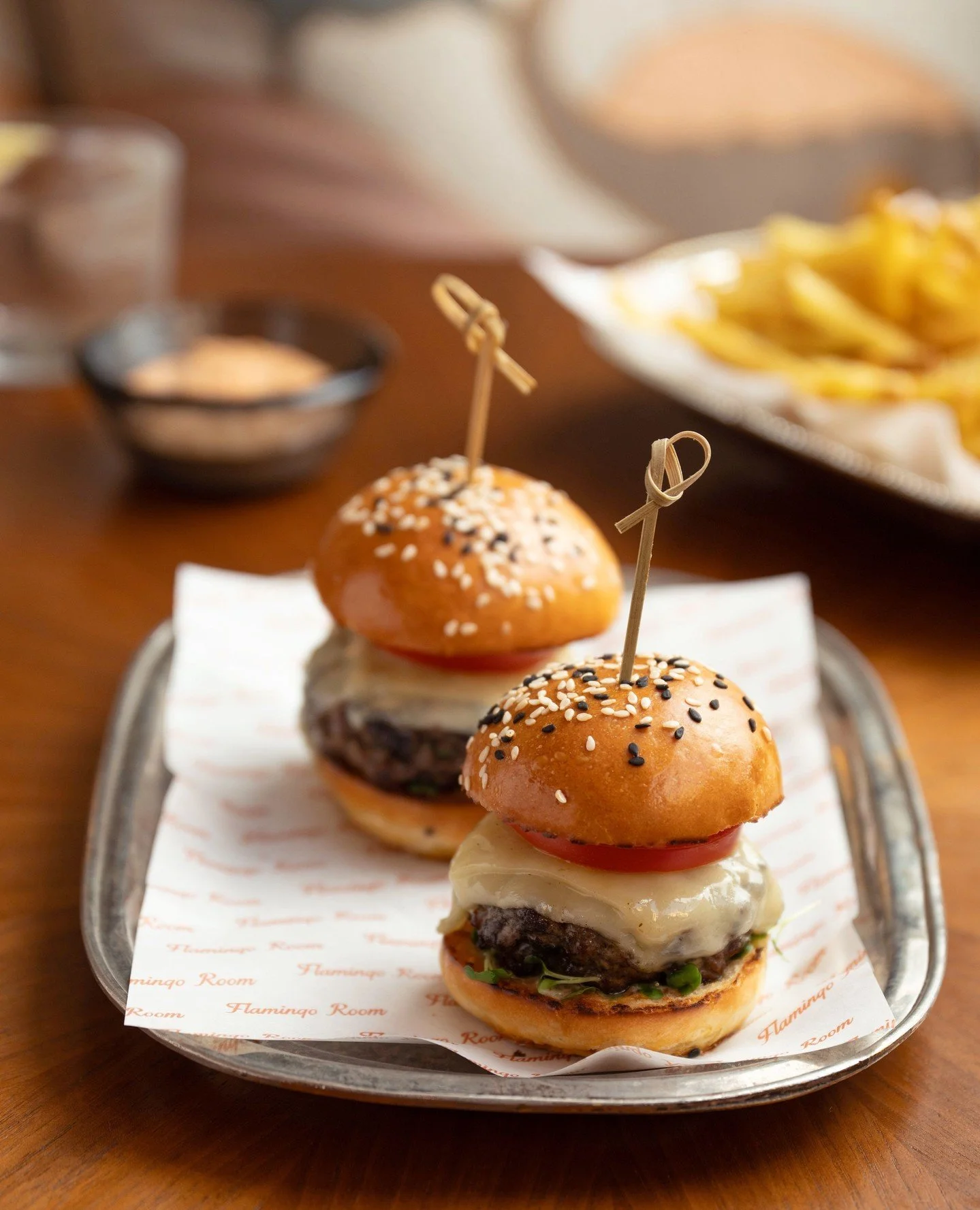 Rich, layered and full of flavour.⁠
⁠
Our Beef Sliders are stacked with veal bacon and onion jam, ranch, emmental, and served with fries.⁠
⁠
#flamingoroomdubai #jumeirahalnaseem #dubairestaurants #flamingoroombytashas #beefsliders