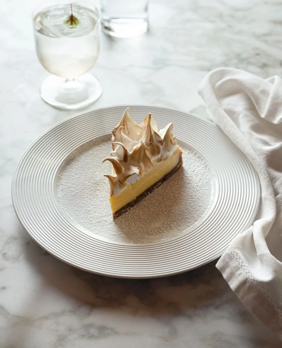 Lizel&rsquo;s Lemon Meringue Tart.⁠
⁠
Named after a dear family friend of Natasha, this is her recipe and a favourite that has remained on the menu over time. A crisp biscuit base with a smooth lemon filling, topped with lightly br&ucirc;l&eacute;ed 