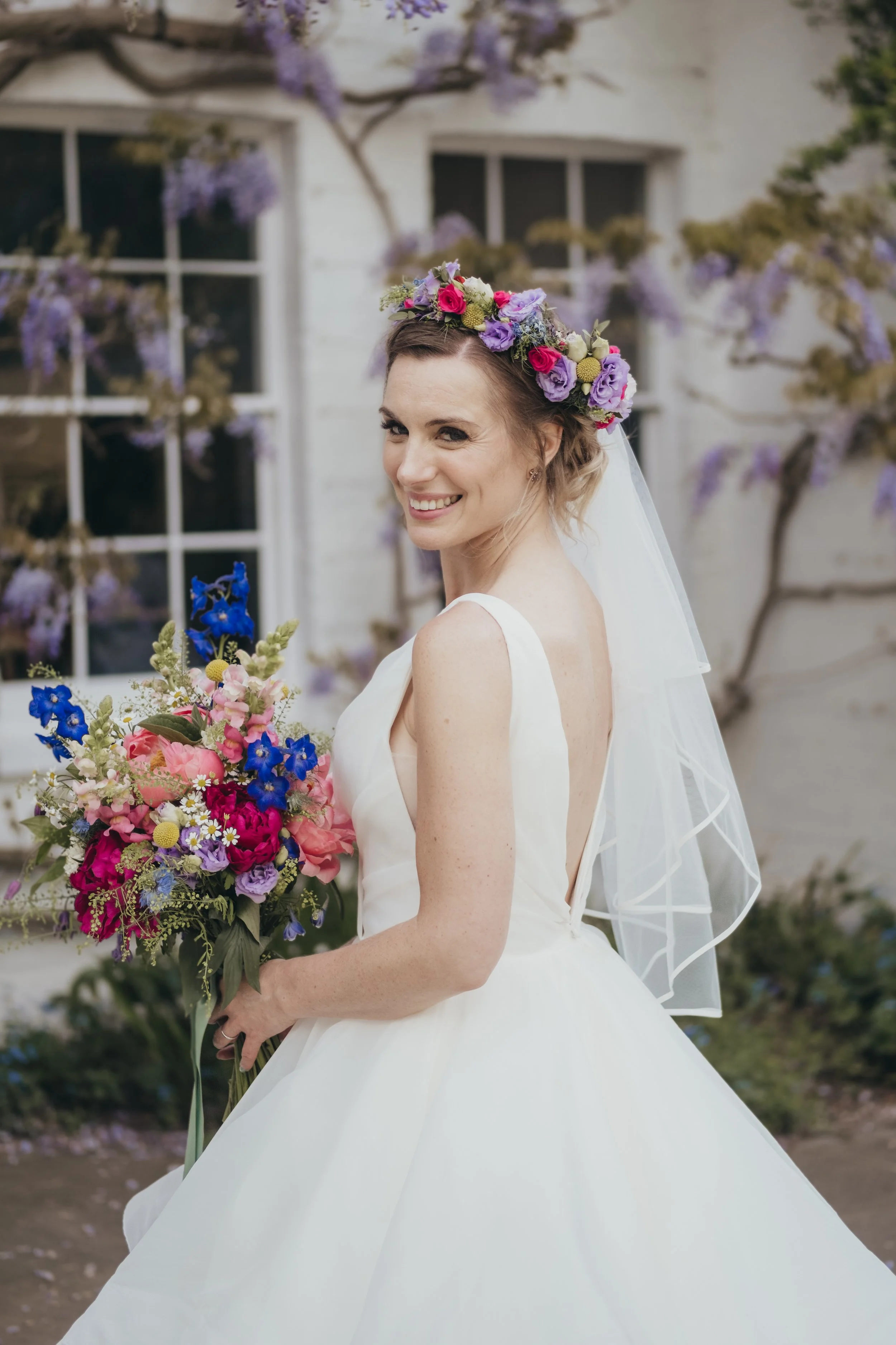Gorgeous bride featuring her colourful, garden flowers bouquet and stunning flower crown. 