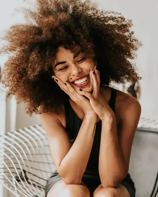 A woman with a large hair style smiling