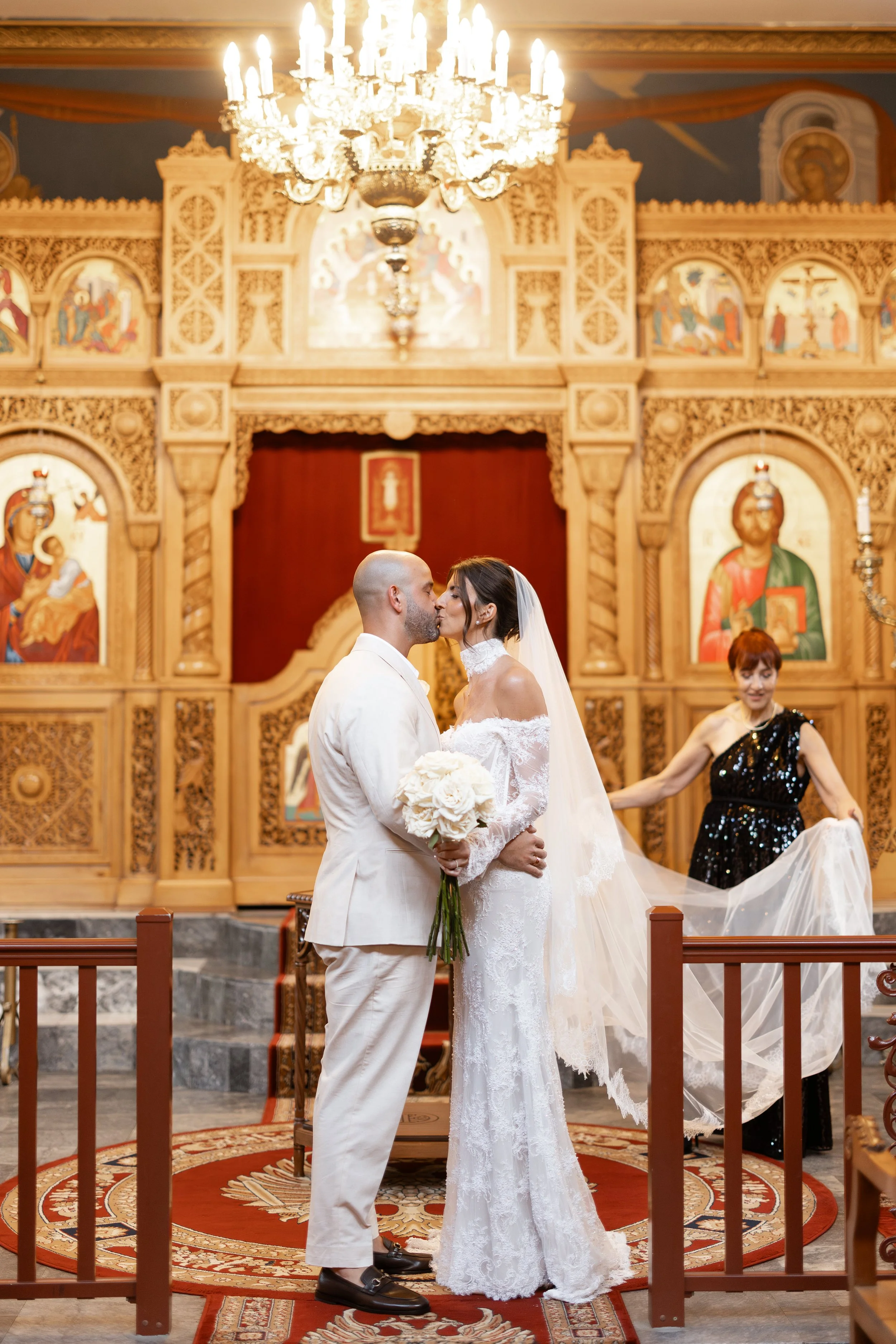 Steph and Alex share a kiss before the altar at Holy Monast