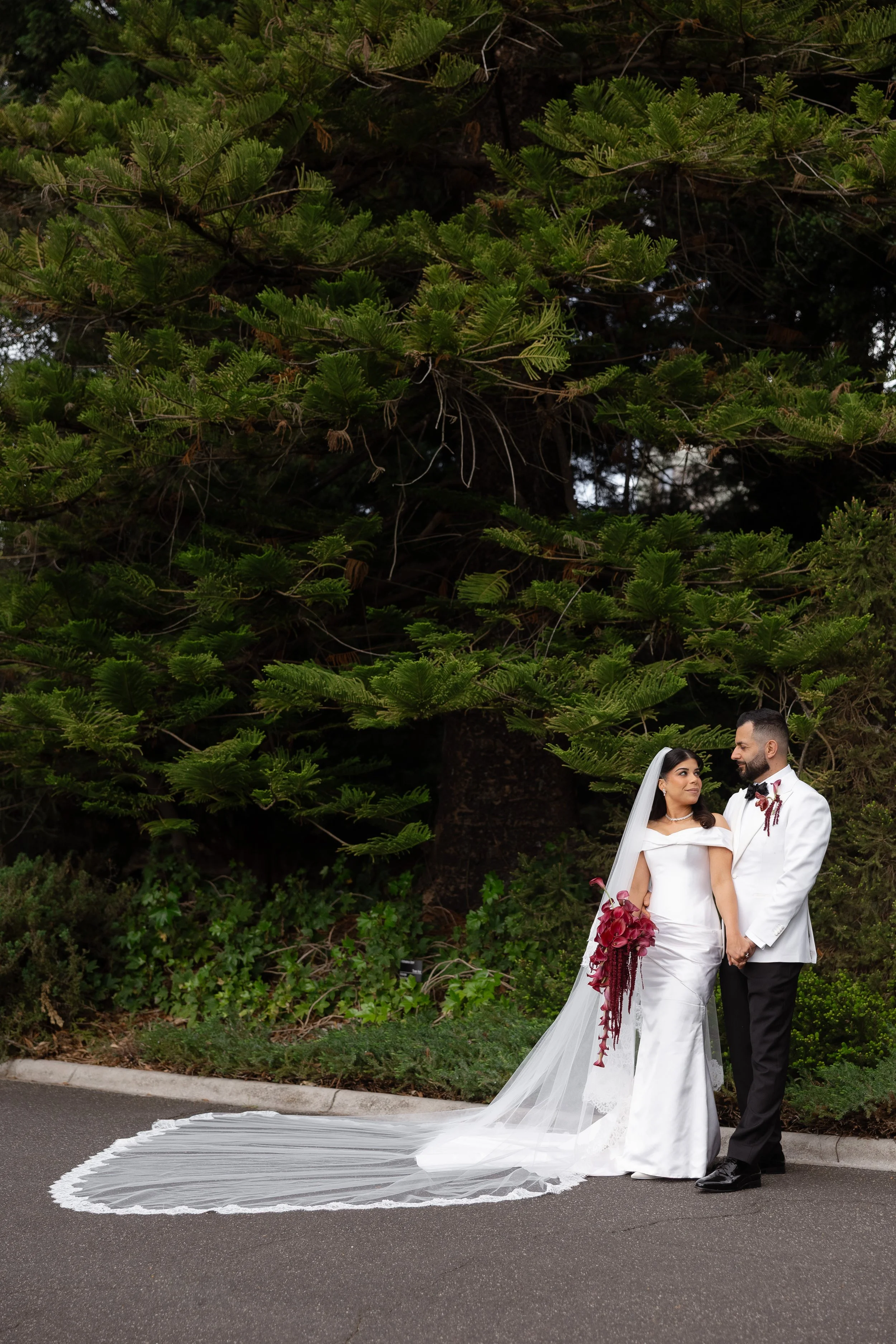 Jihan and Rob beneath tall trees in the Royal Botanic Gardens Melbourne