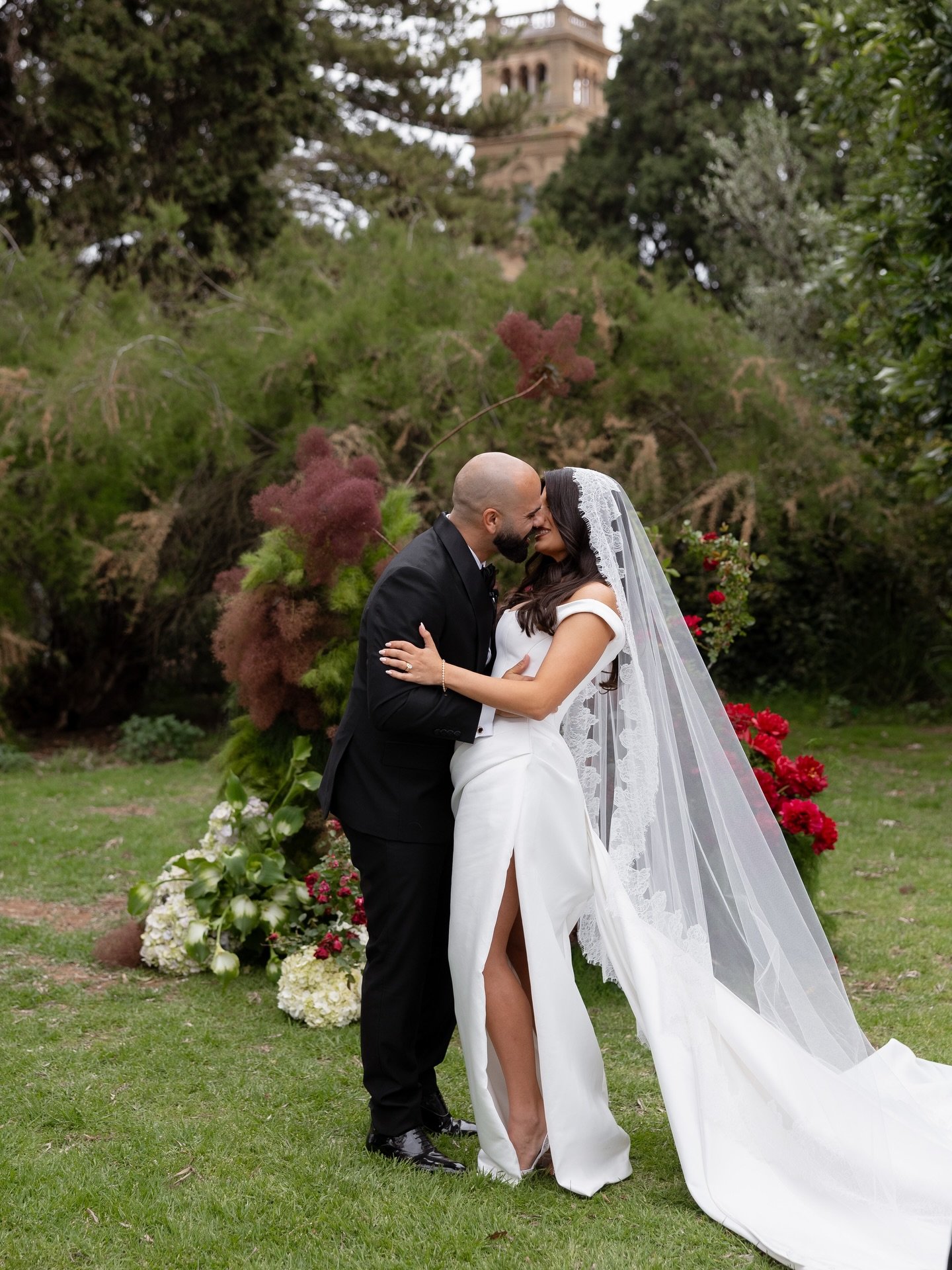 Georgia and George&rsquo;s Werribee Mansion wedding embraced a luxurious palette of burgundy, lush greenery, and cream, woven through every detail from the florals to the romantic outdoor reception. 

The ceremony unfolded in the mansion&rsquo;s gard