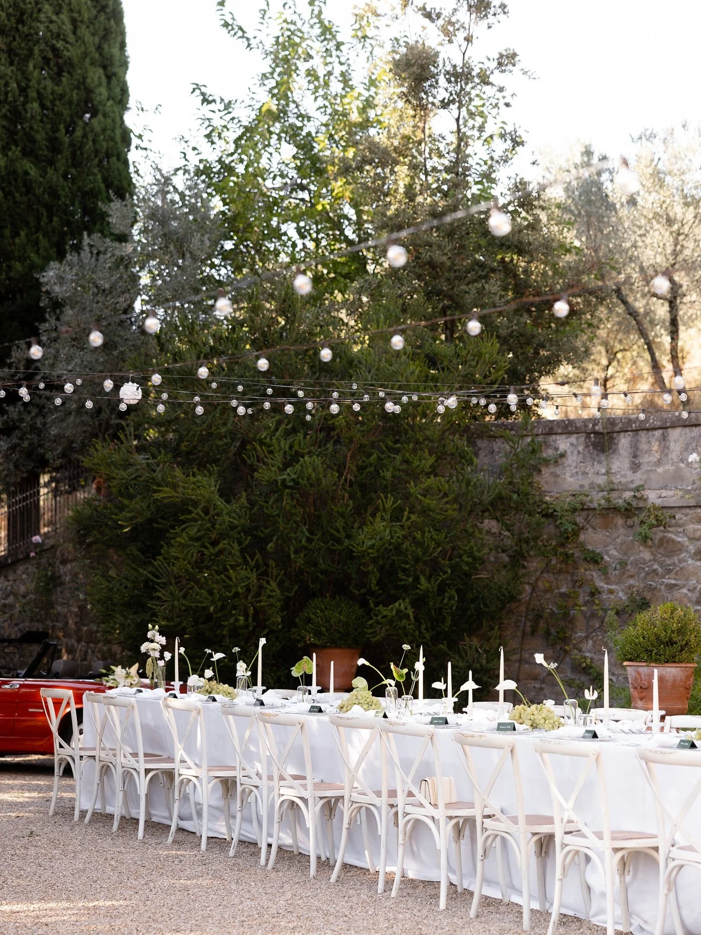 Outdoor wedding dinner table beneath trees at Villa Belvedere