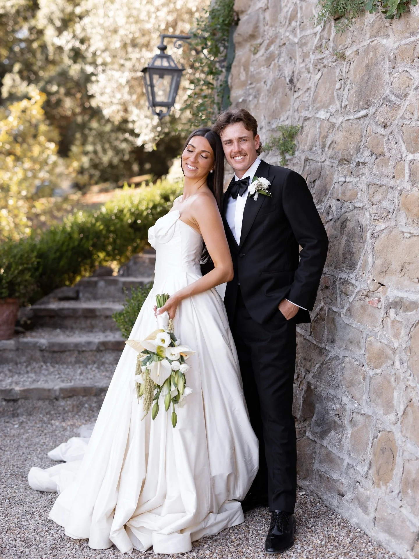Marilena and Joshua standing together after their ceremony, bride holding her bouquet