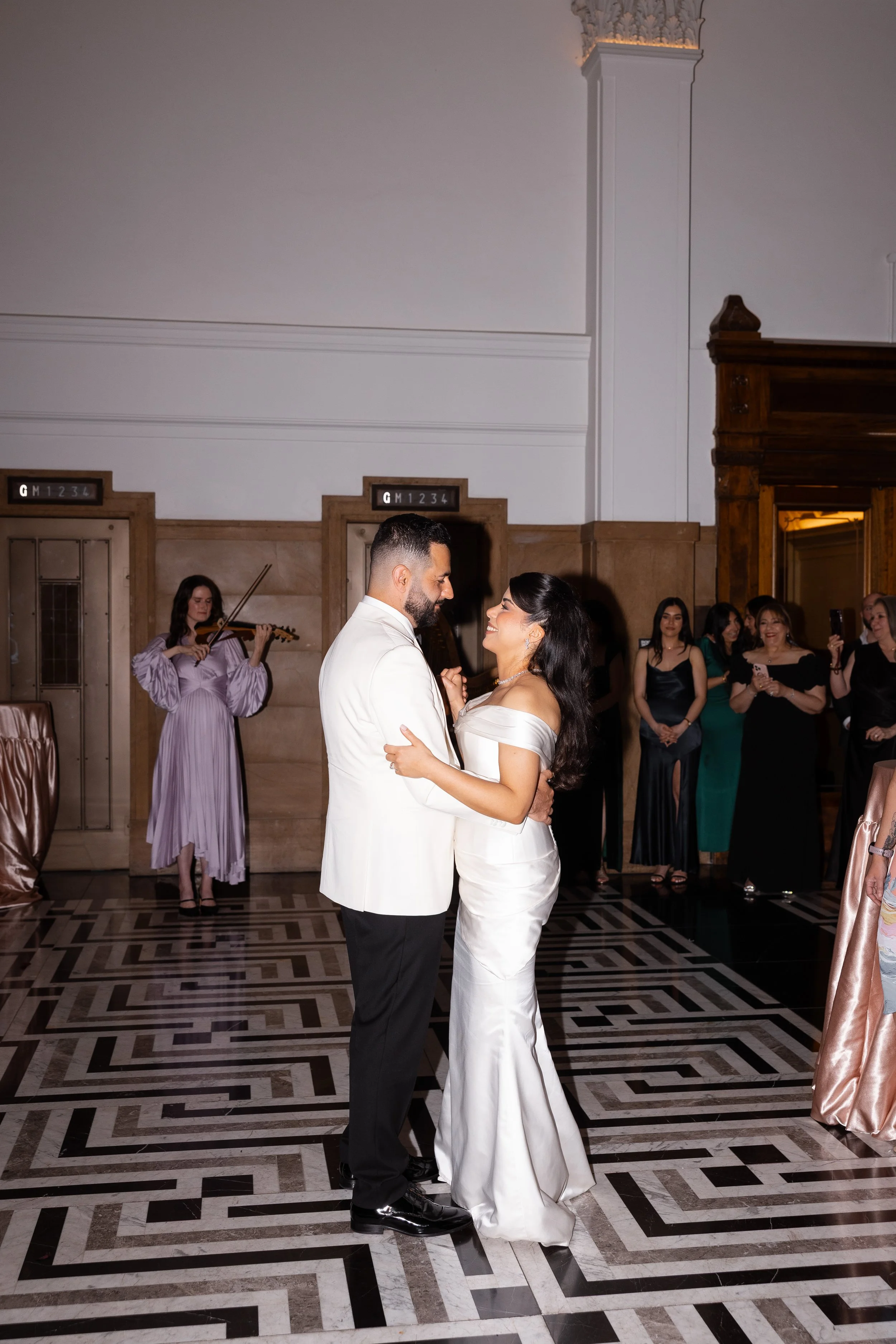 Jihan and Rob dancing on the black-and-white floor at Luci Melbourne