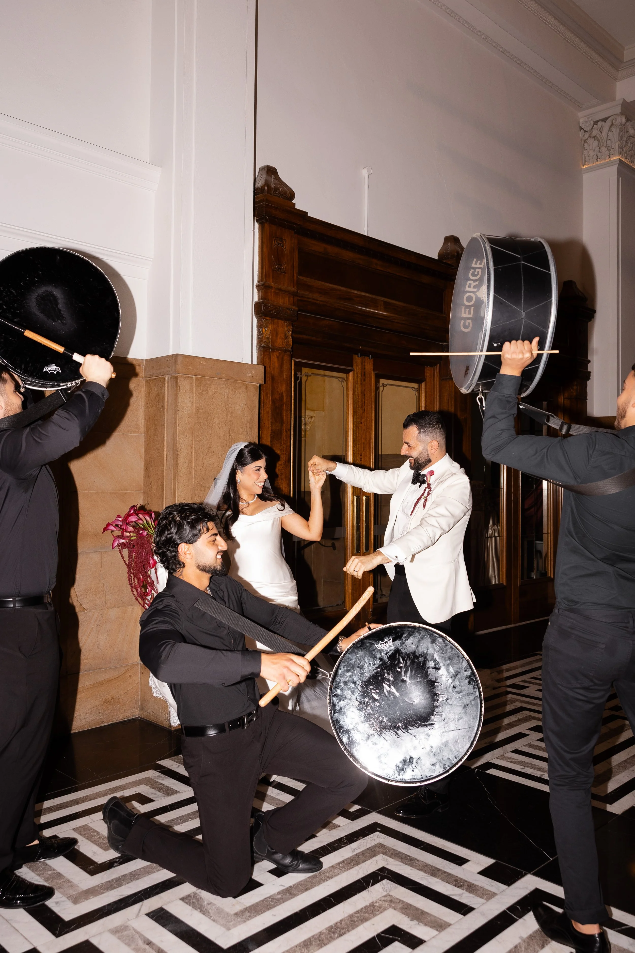 Jihan and Rob dancing as drummers perform around them at Luci Melbourne