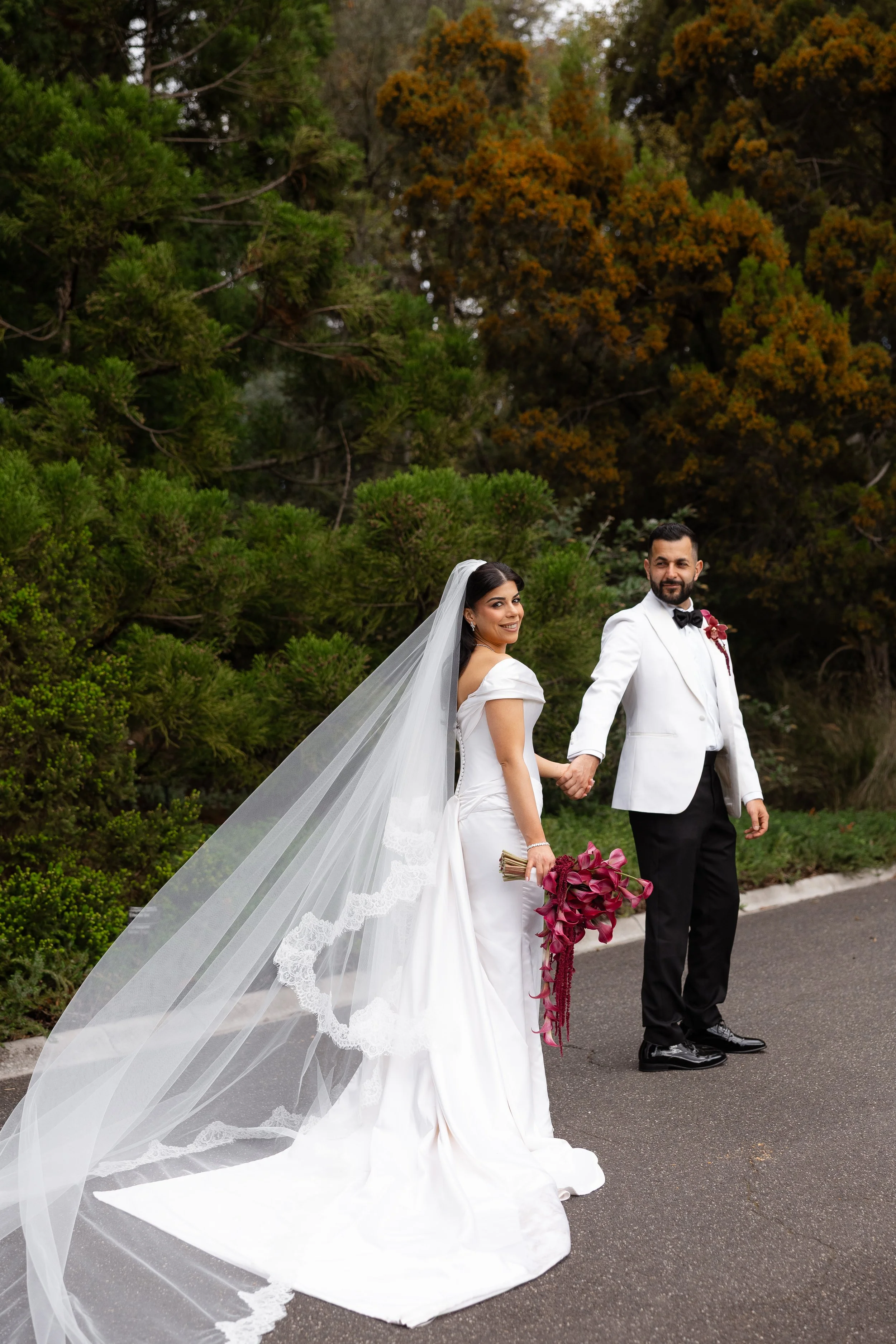 Jihan and Rob walking hand in hand in the Royal Botanic Gardens Melbourne