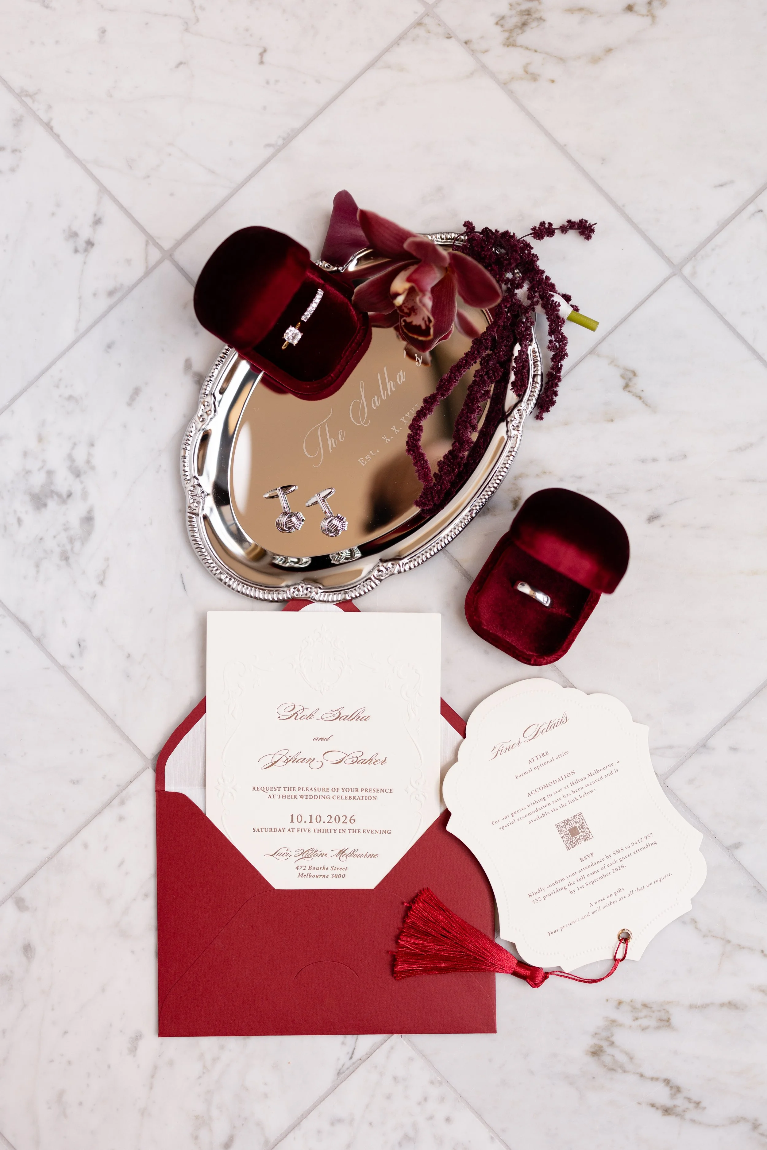 Jihan and Rob’s red invitation suite with wedding rings on a silver tray