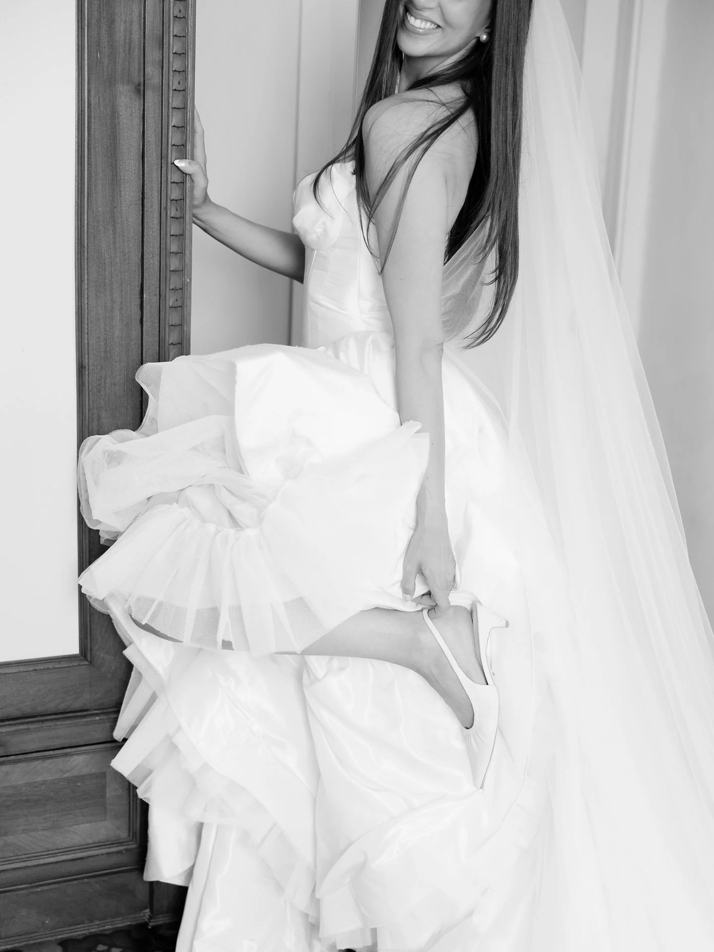 Black and white detail of the voluminous skirt of Marilena's wedding gown