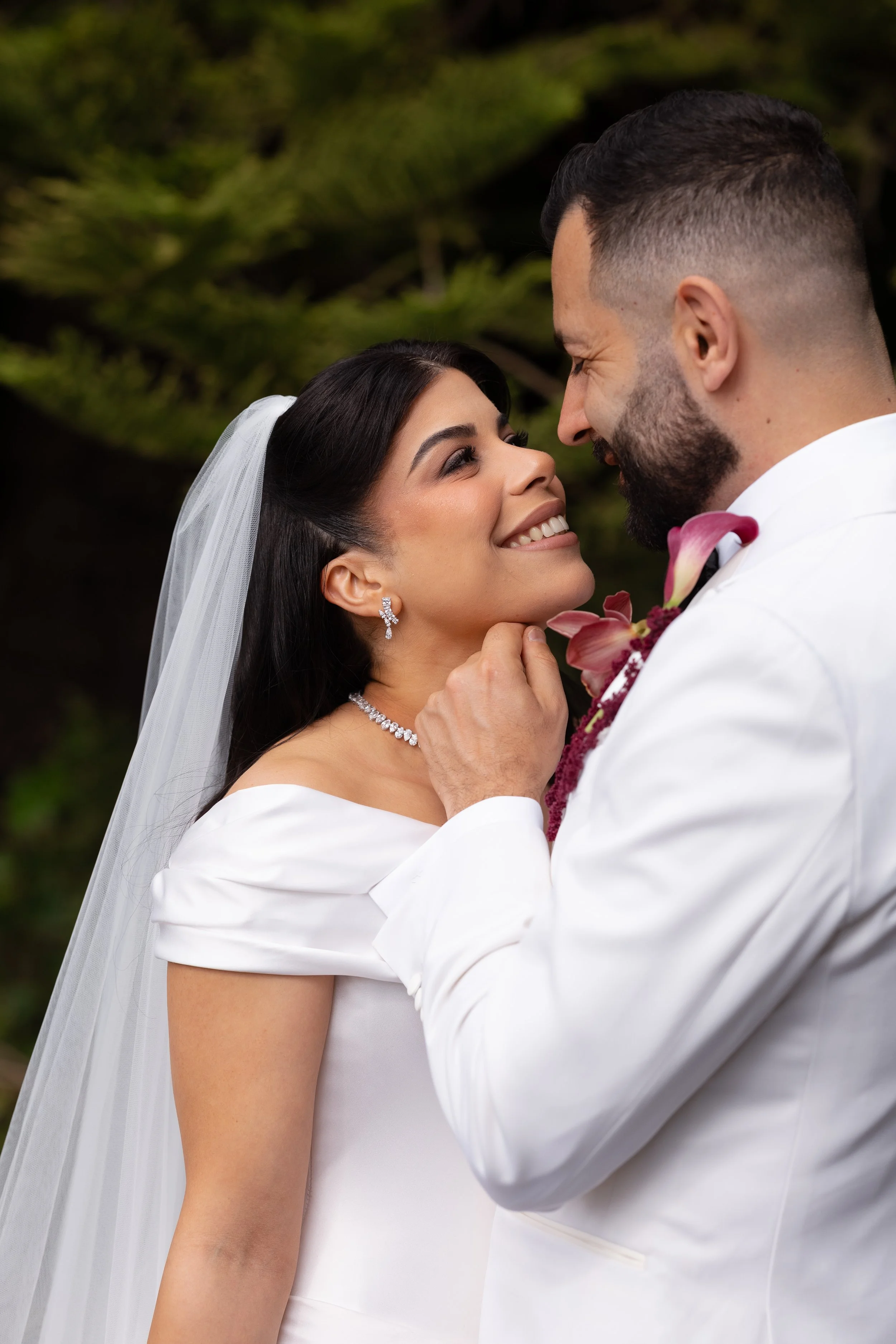 Jihan and Rob in a close embrace, her veil resting on his shoulder