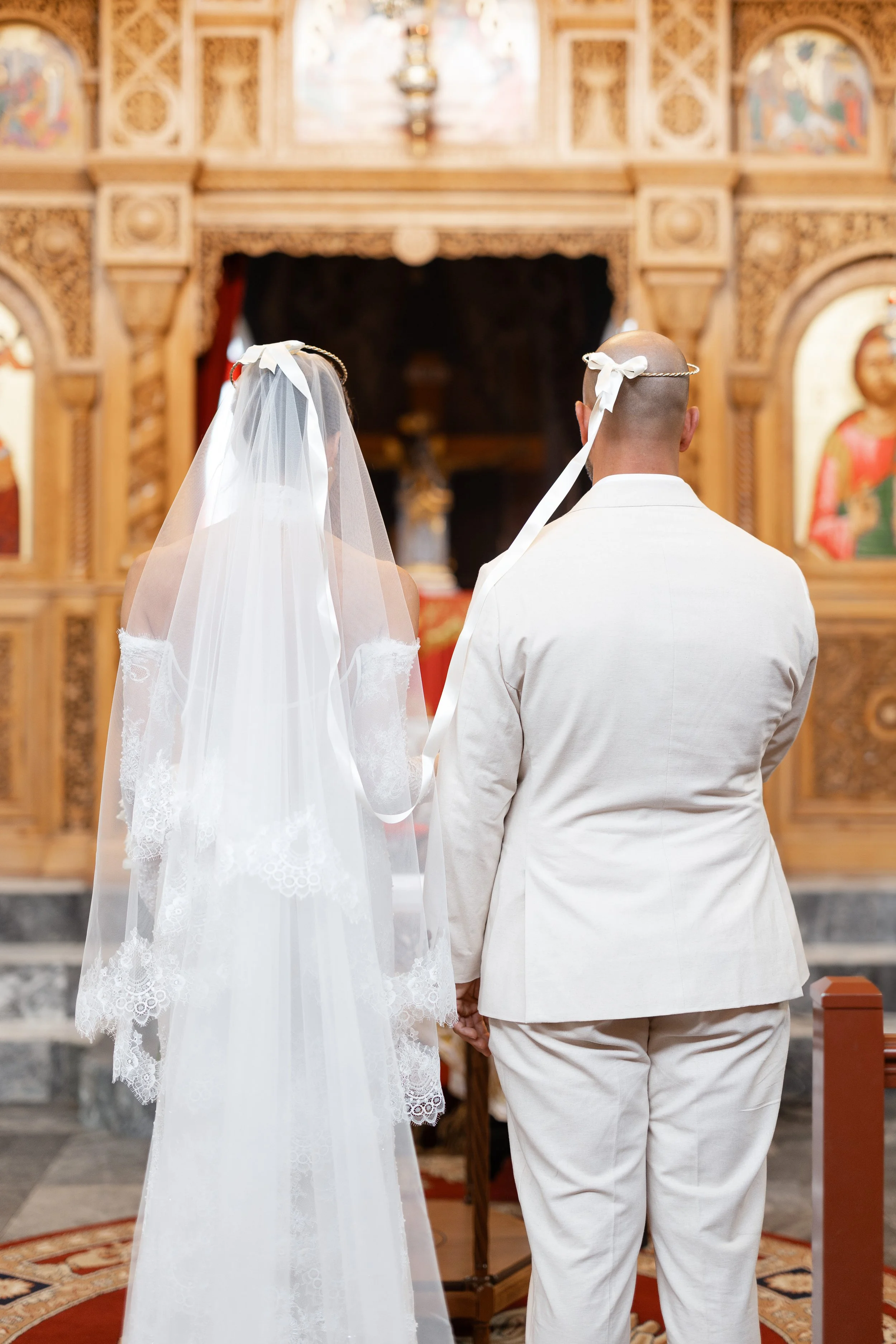 Steph and Alex at the altar of Holy Monastery of Panagia Kamariani, her long veil flowing