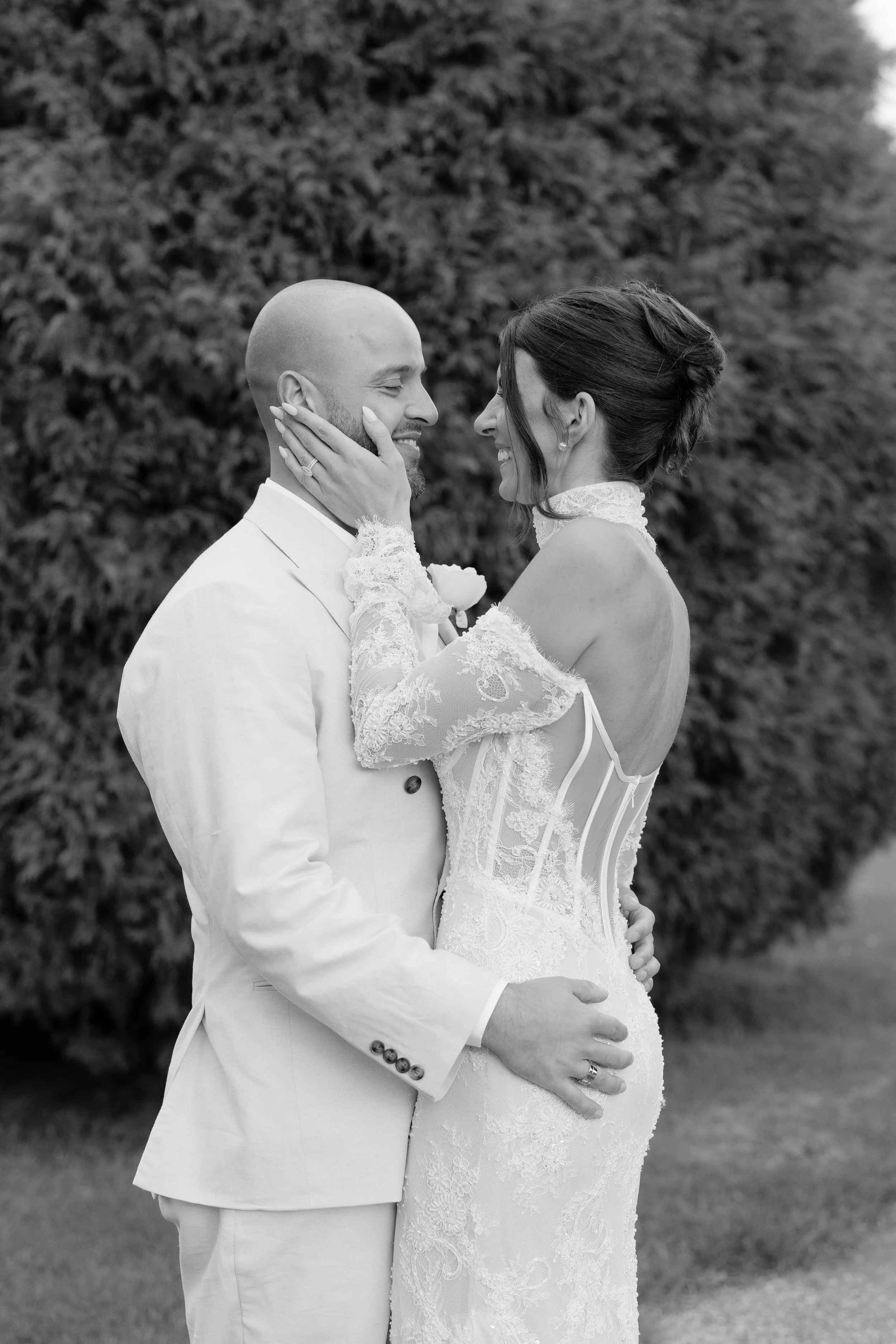 Steph and Alex embrace in black and white at Lindenderry Red Hill