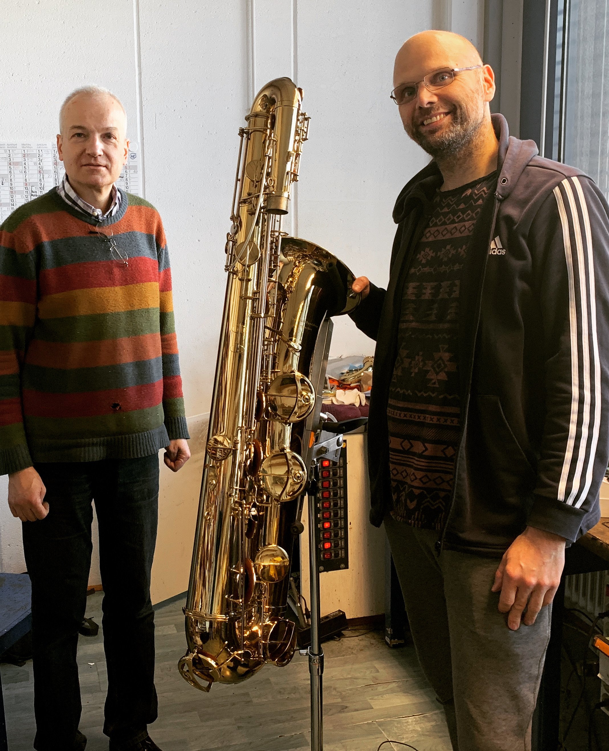 Benedikt Eppelsheim posing with Ties and his Eppelsheim bass saxophone.
