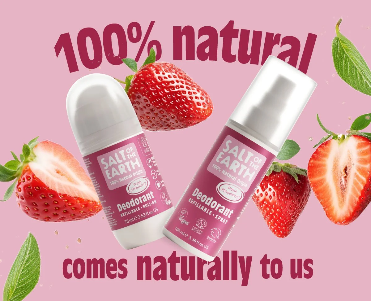 Pink background with strawberries, green leaves, and two Salt of the Earth deodorant bottles labeled 100% natural, strawberry scent, and refillable, spray and roll-on types.