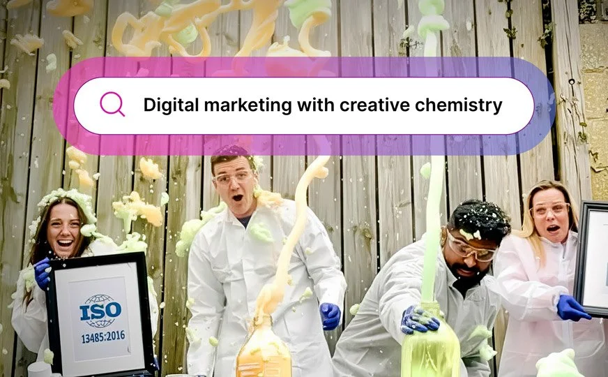 YouSeq scientists in lab coats and safety gloves are having fun with colorful foam and liquids splashing in a science experiment to celebrate new accreditations with search bar overlay with the text 'Digital marketing with creative chemistry'.