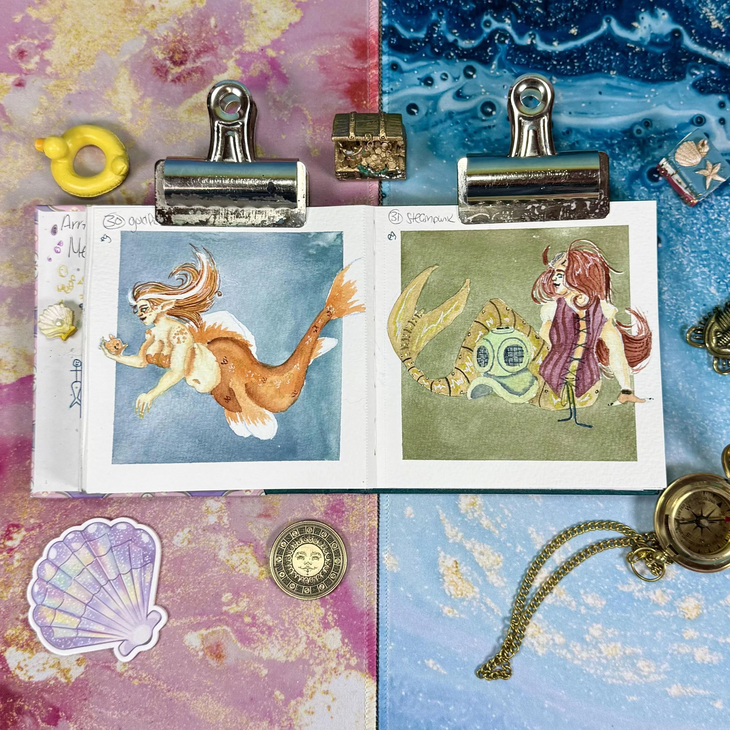 A goldfish mermaid and a steampunk mermaid