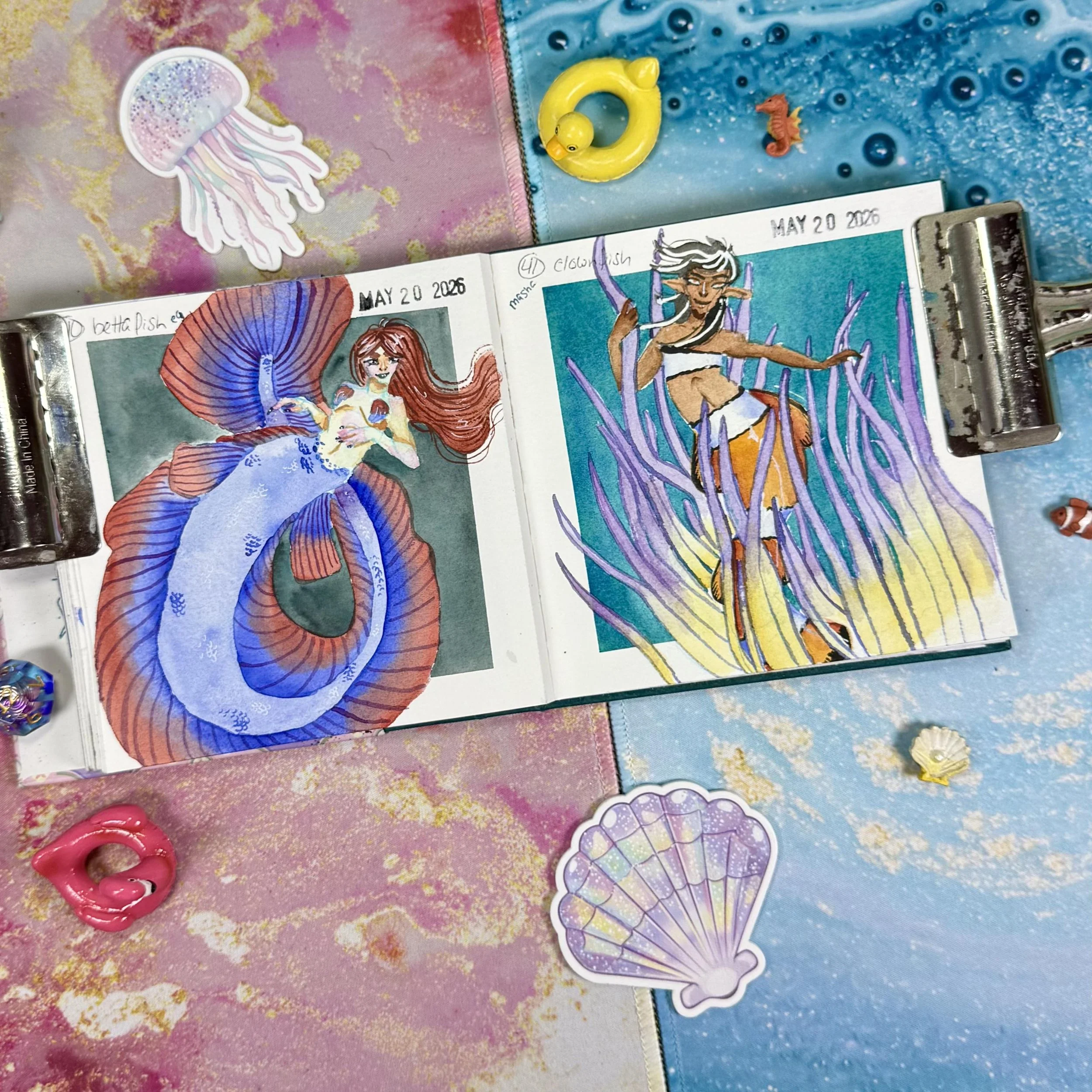 A betta fish mermaid and a clownfish mermaid