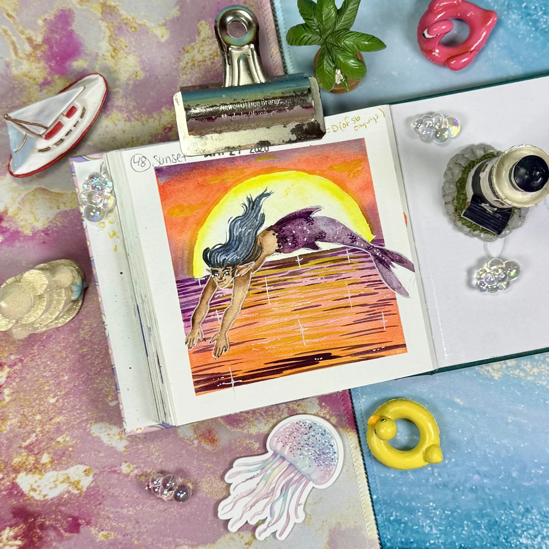 a mermaid jumping into the ocean framed by a sunset