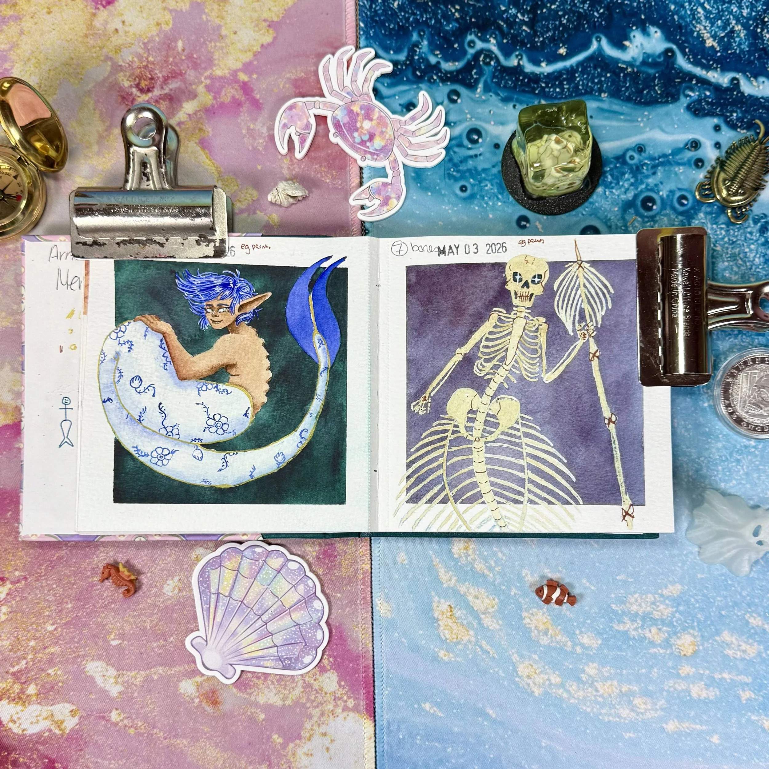 A porcelain mermaid and a skeletal mermaid