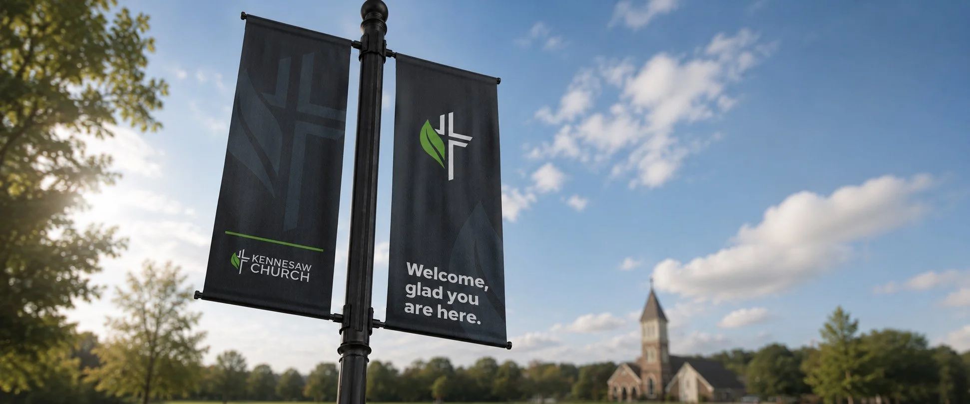 Outdoor church welcome banner for Kennesaw Church with the message, "Welcome, glad you are here"