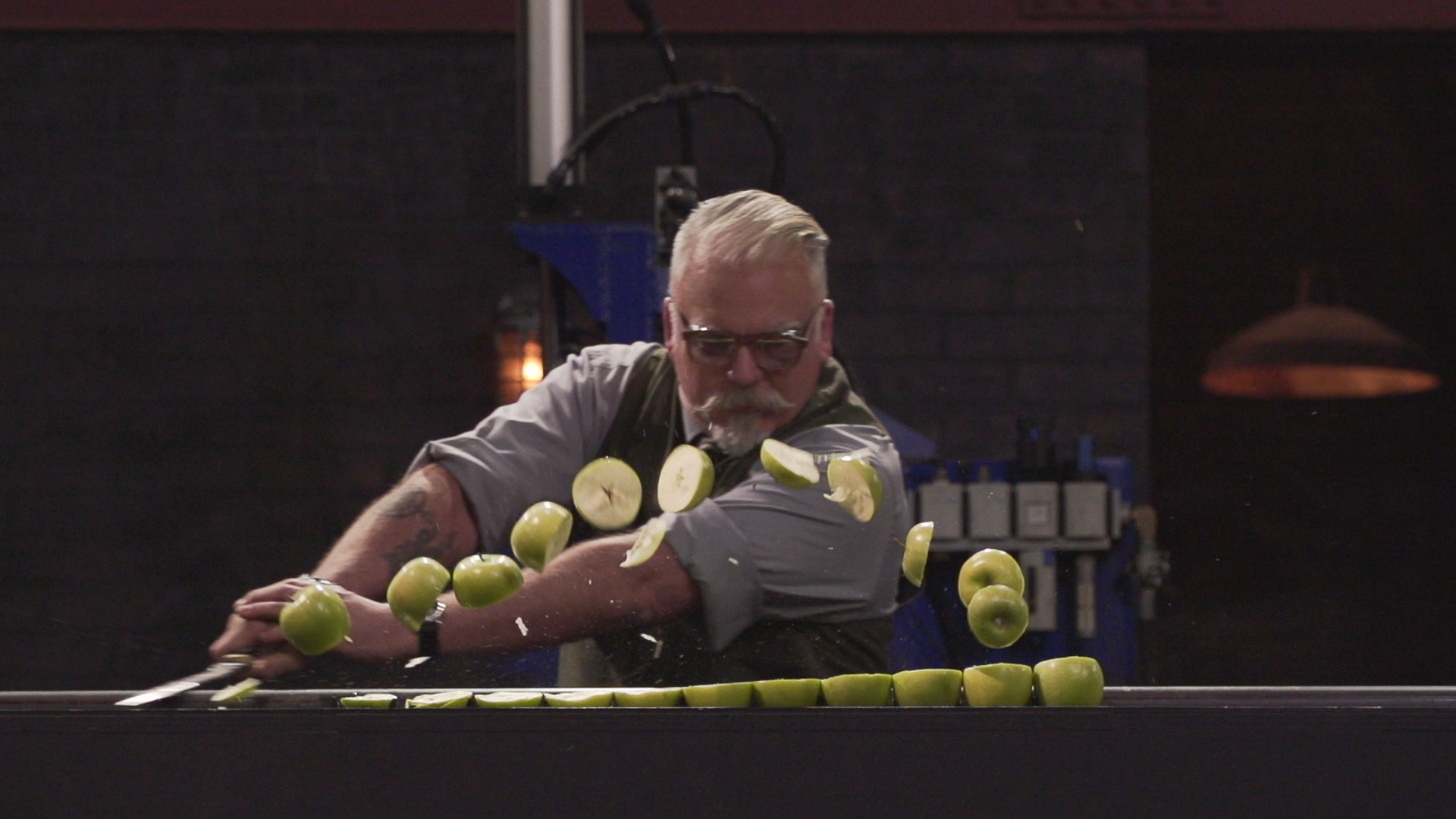 David Baker slices apples during a sharpness test.