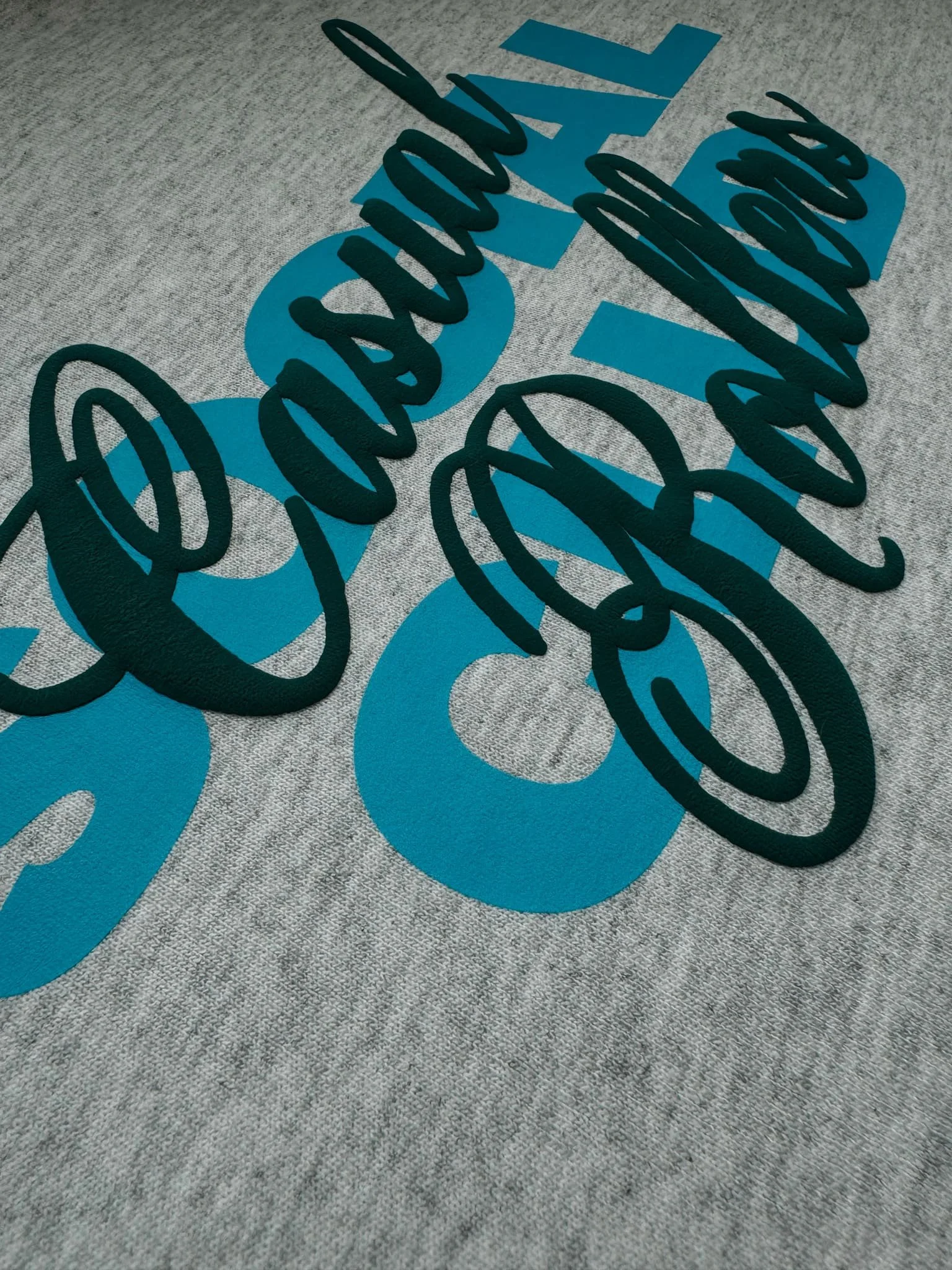 Close up showing raised puffy design for Casual Rollers sweatshirt.