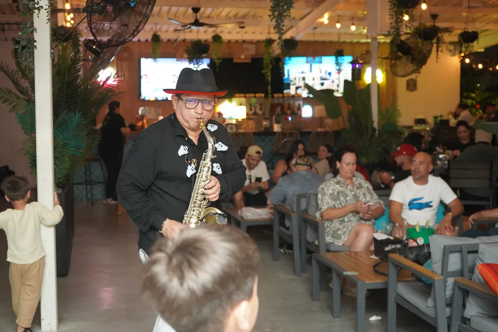 Live saxophonist performing for guests under string lights at La Yardita