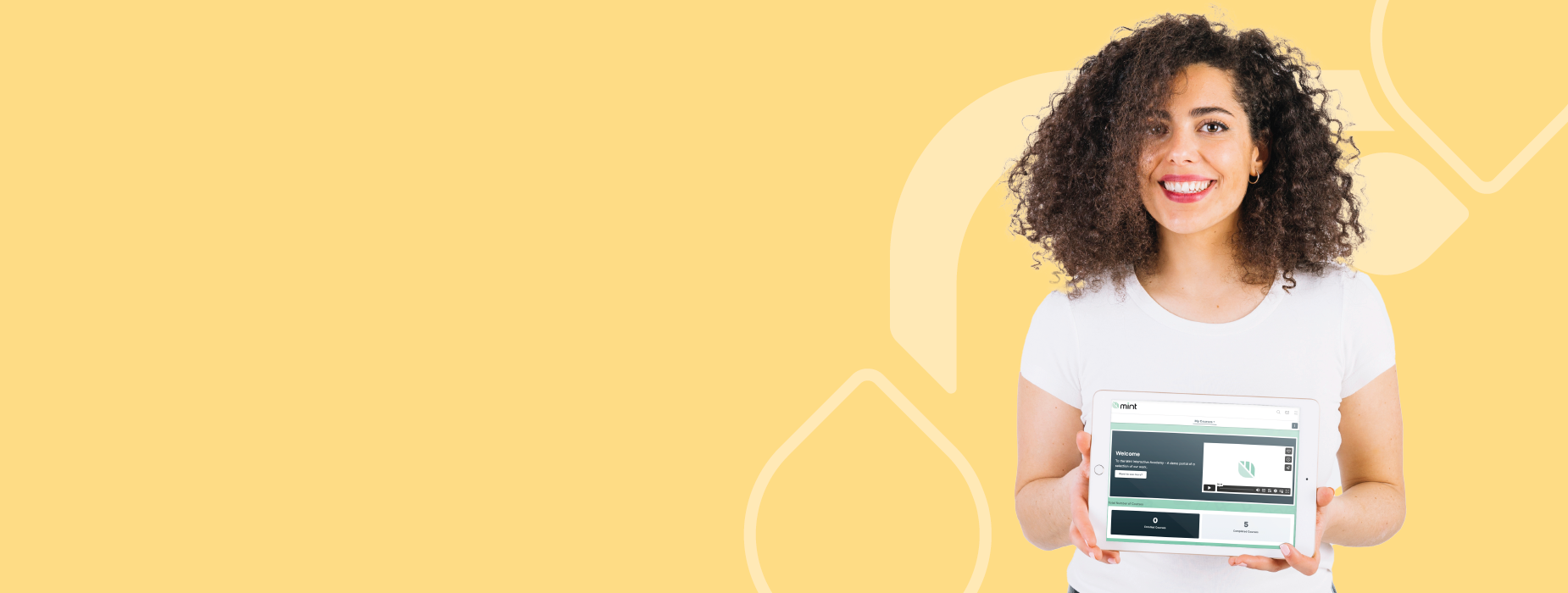A young woman with curly hair holding a tablet with a website displayed on it, smiling against a yellow background with abstract shapes.