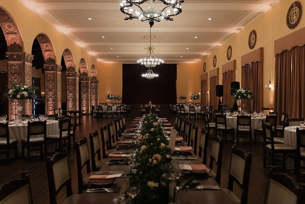 In our magnificent Dining Room, you&rsquo;ll find intricately carved archways and a stage built in. This space was elegantly converted into Christina and Matt&rsquo;s formal dinner reception room. Adorned with their selected greenery, soft whites, an