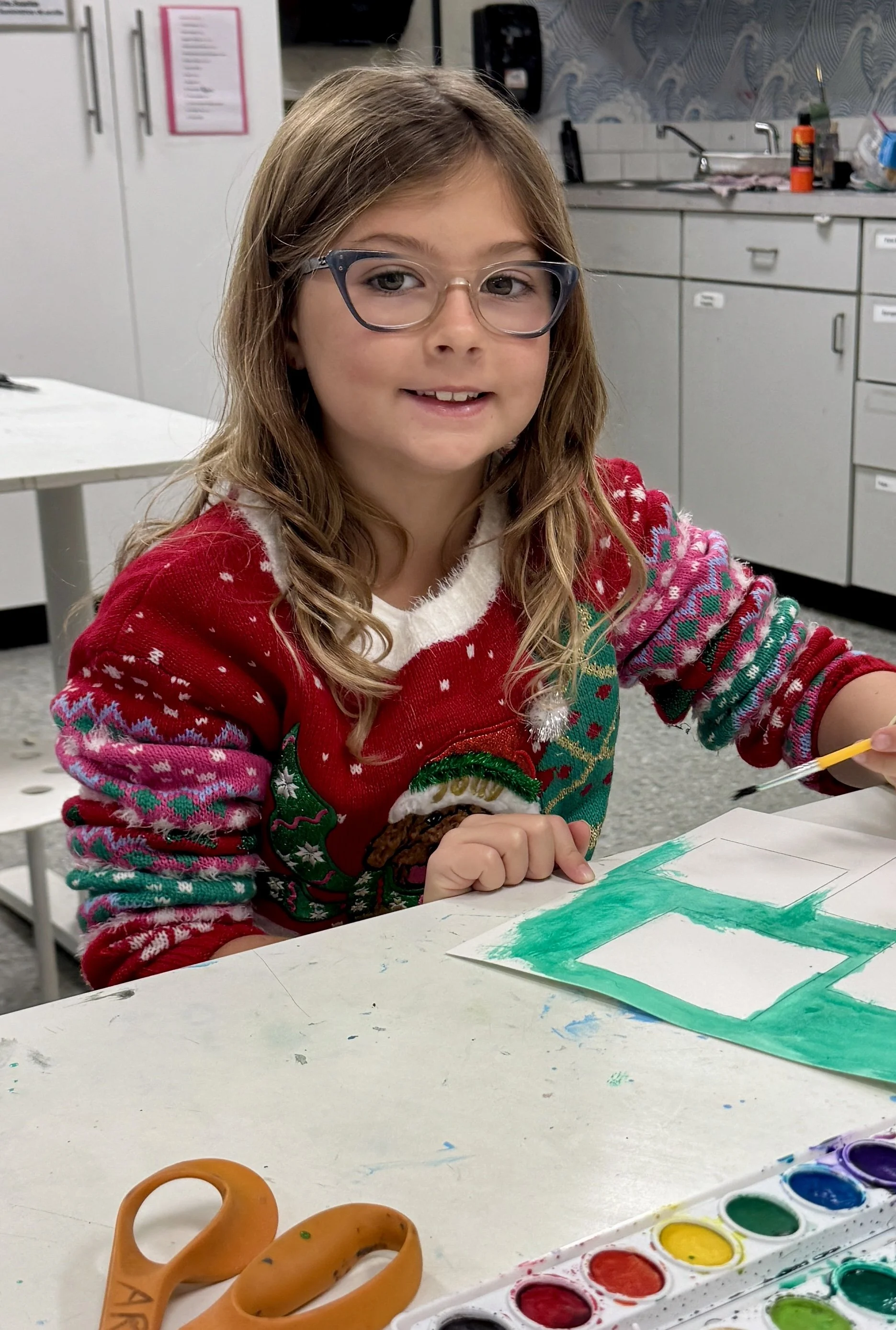 Child working on frog art piece