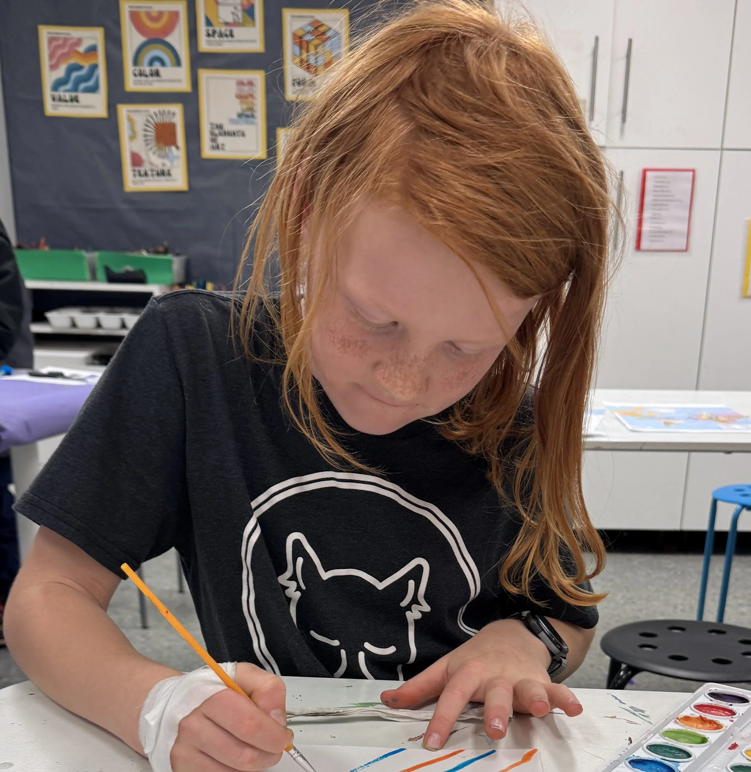 Child working on frog art piece