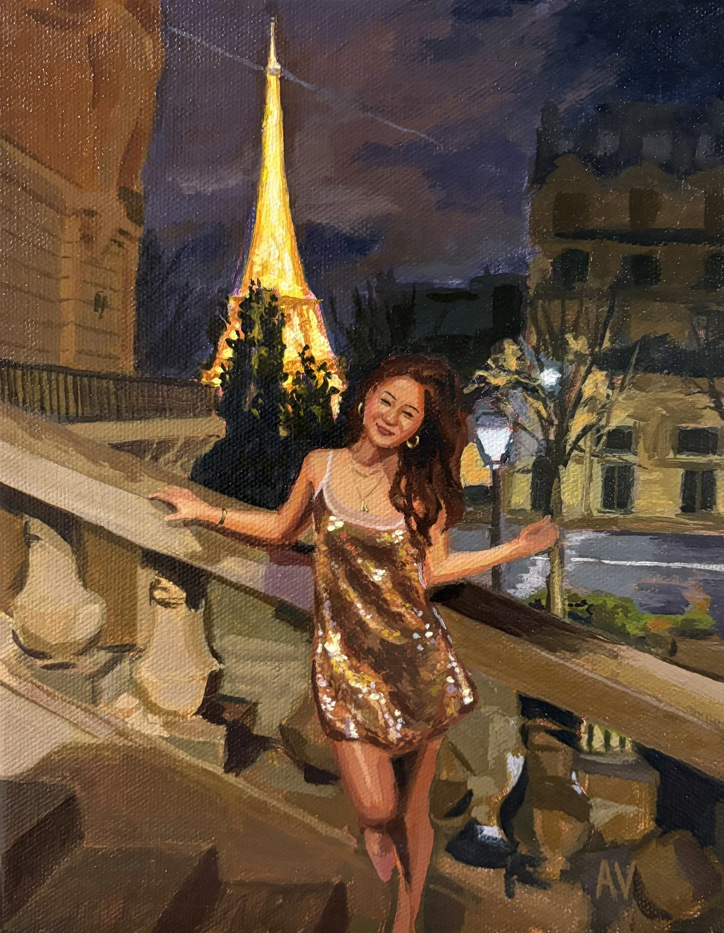 A woman in a shiny, gold dress smiling and posing on a balcony at night, with the Eiffel Tower lit up in the background.