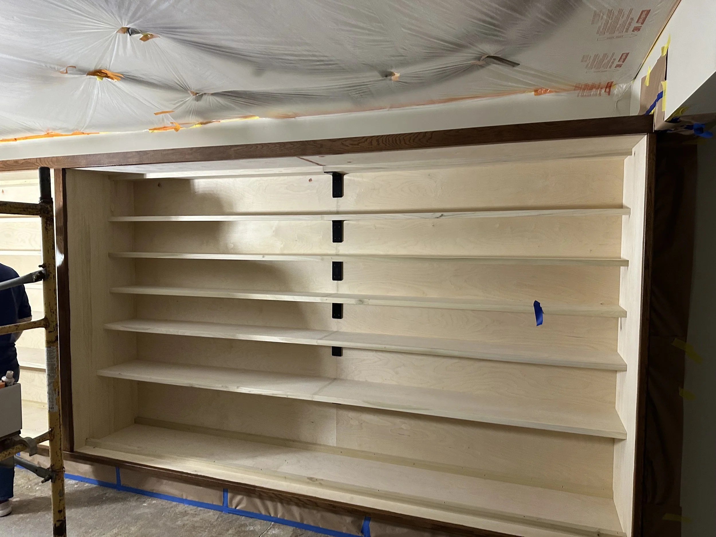  Close-up of one shelving unit with visible shelf-pin hardware down the center divider. 