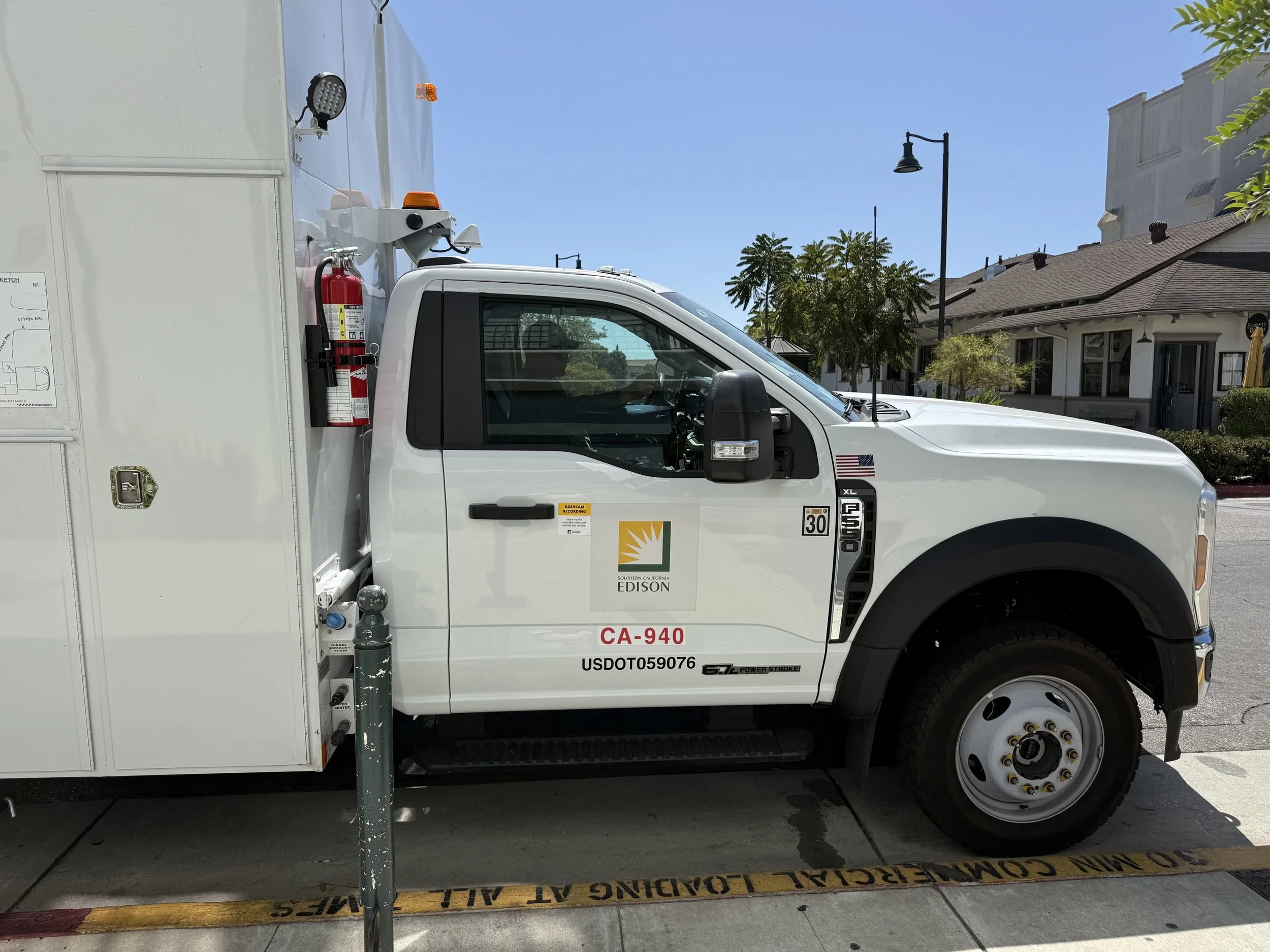  Southern California Edison service truck (CA-940) parked curbside outside the building. 